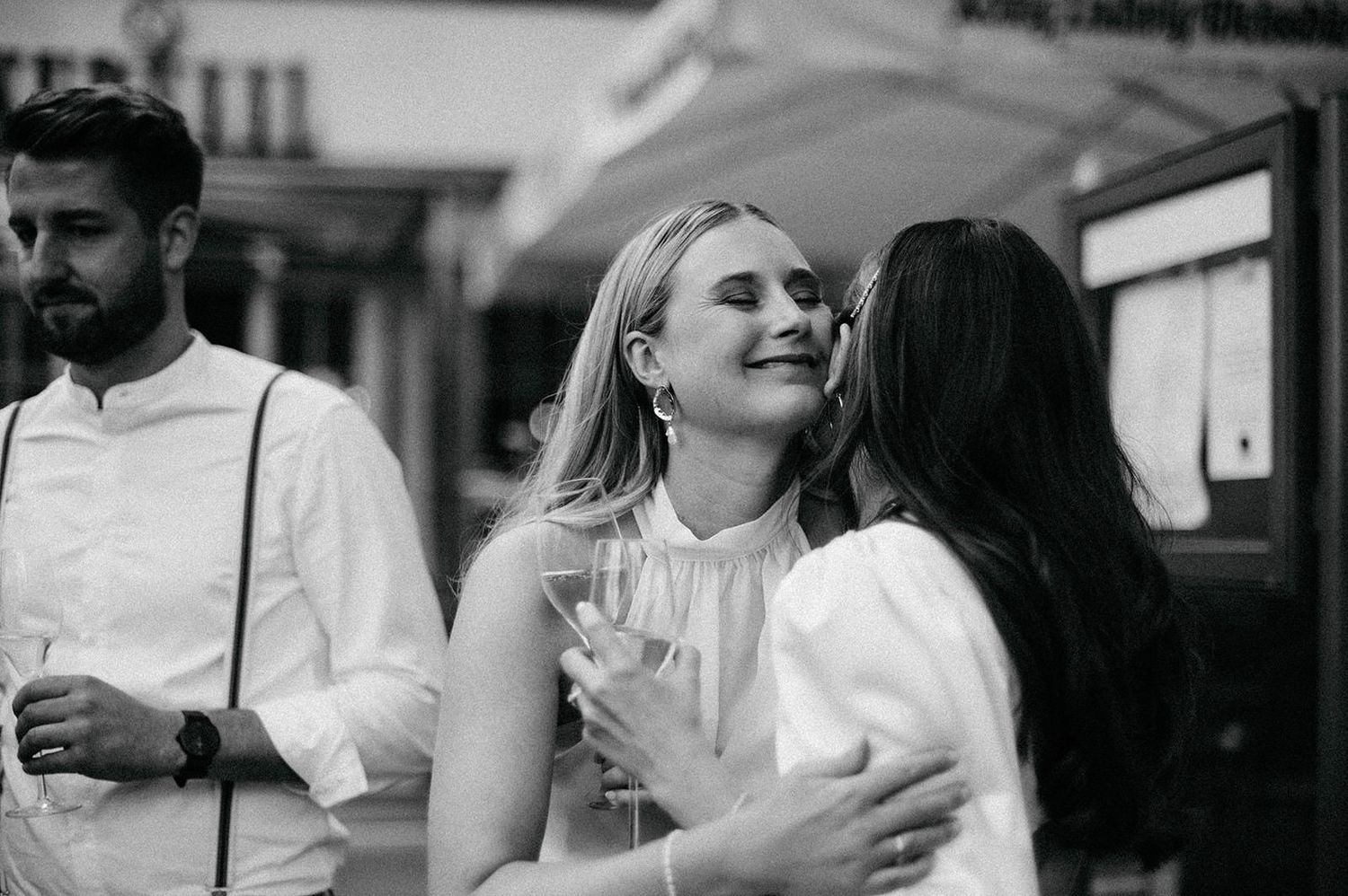 Black and white photo montage showing intimate wedding moments with couples embracing and sharing joyful interactions.