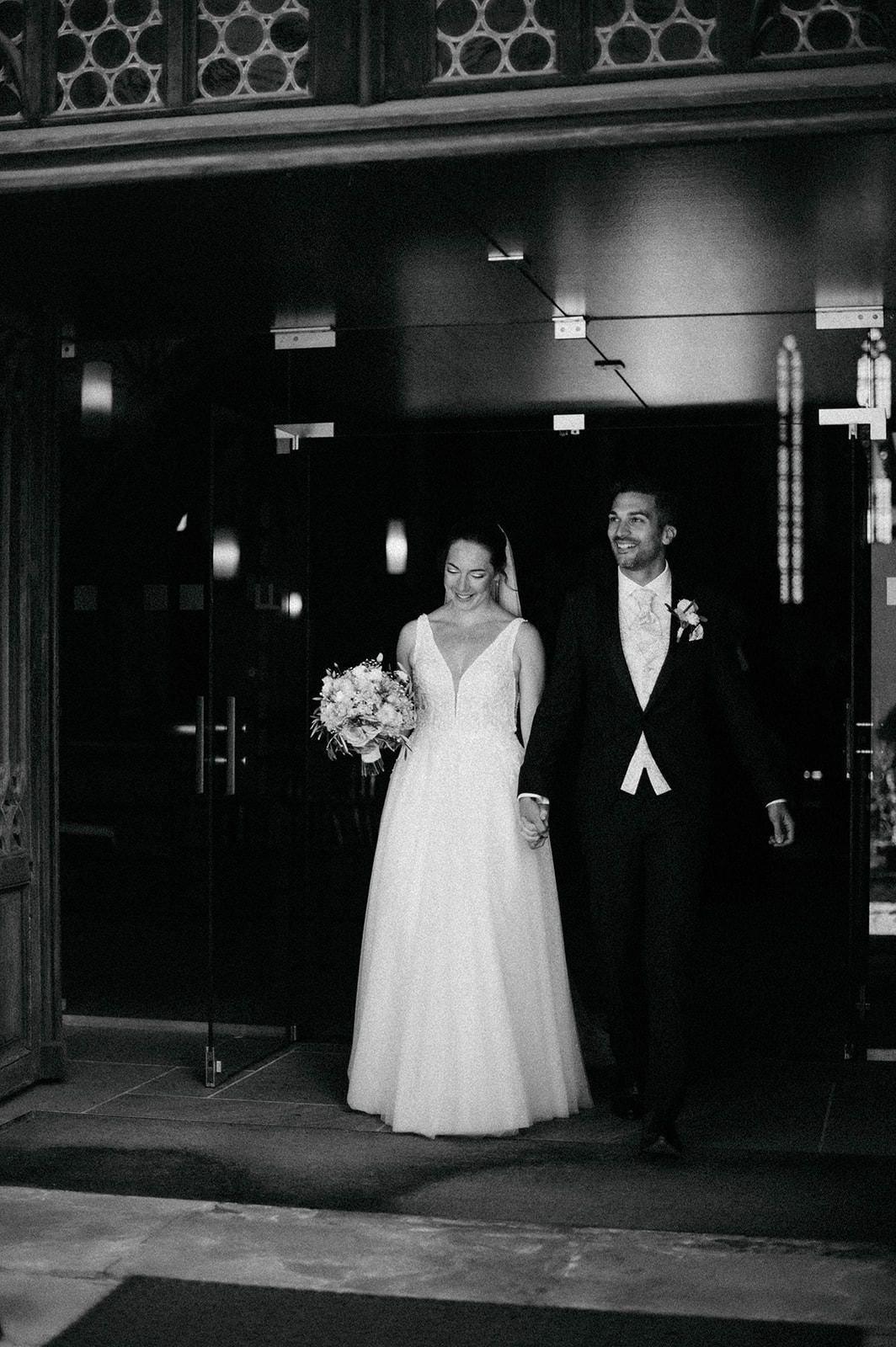 Black and white wedding photographs show a bride and groom exiting a building in formal attire at night.