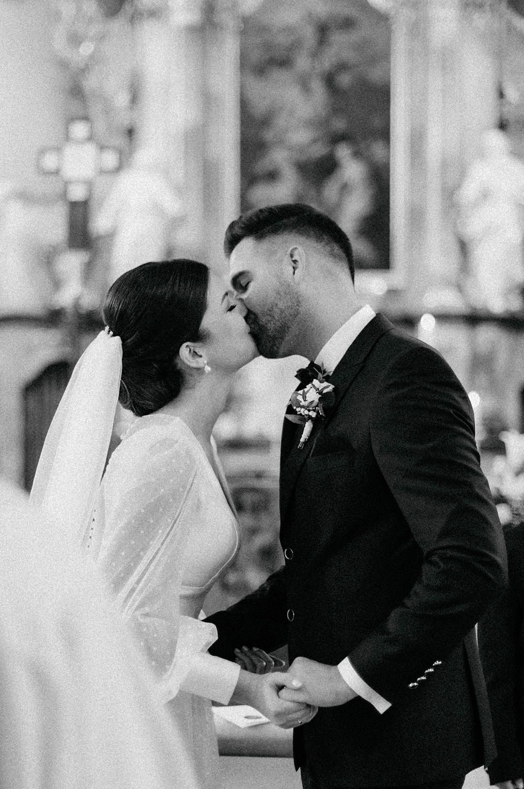 A black and white photo series shows a romantic wedding couple sharing intimate kisses in formal attire.