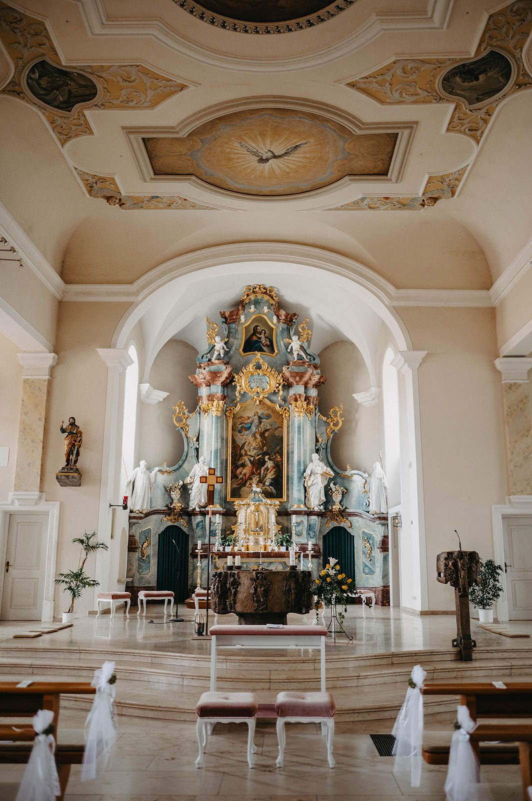Three panoramic views of an ornate white church interior with baroque altars and decorative ceiling details.