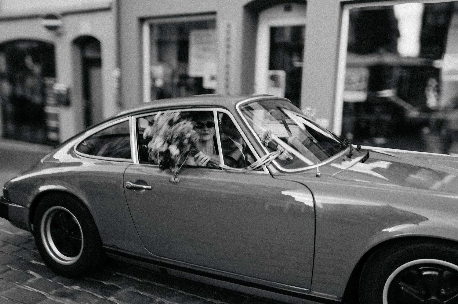 A row of vintage Porsche 911 sports cars parked in a line showcasing their iconic profiles and designs.