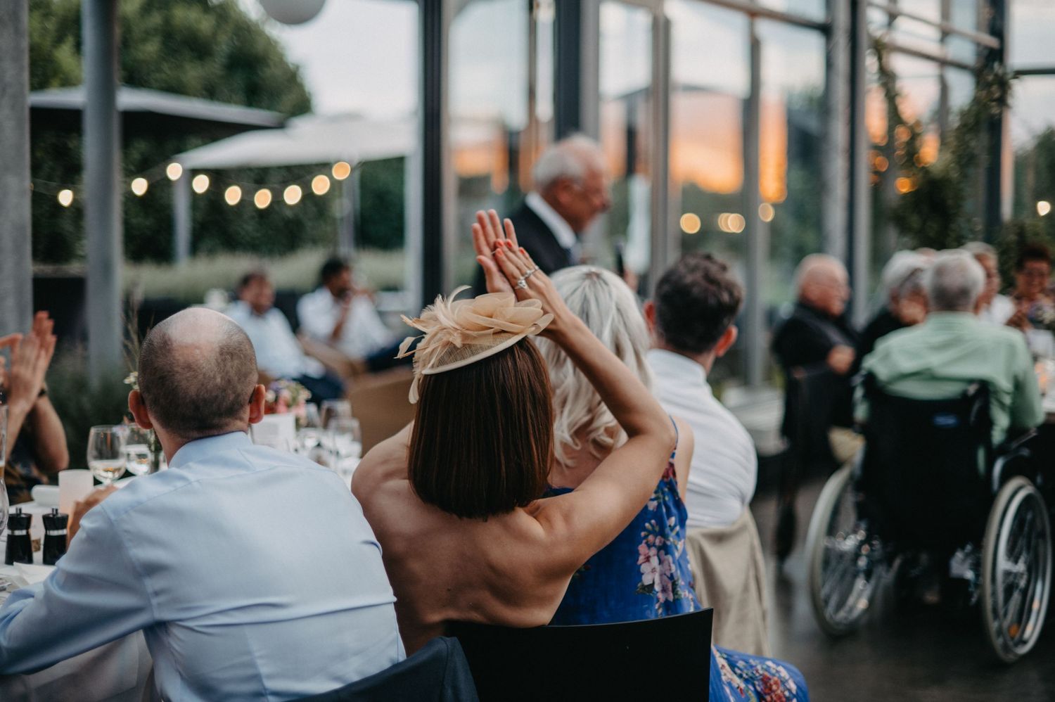 Wedding reception venue at sunset with string lights creating a warm outdoor ambiance.