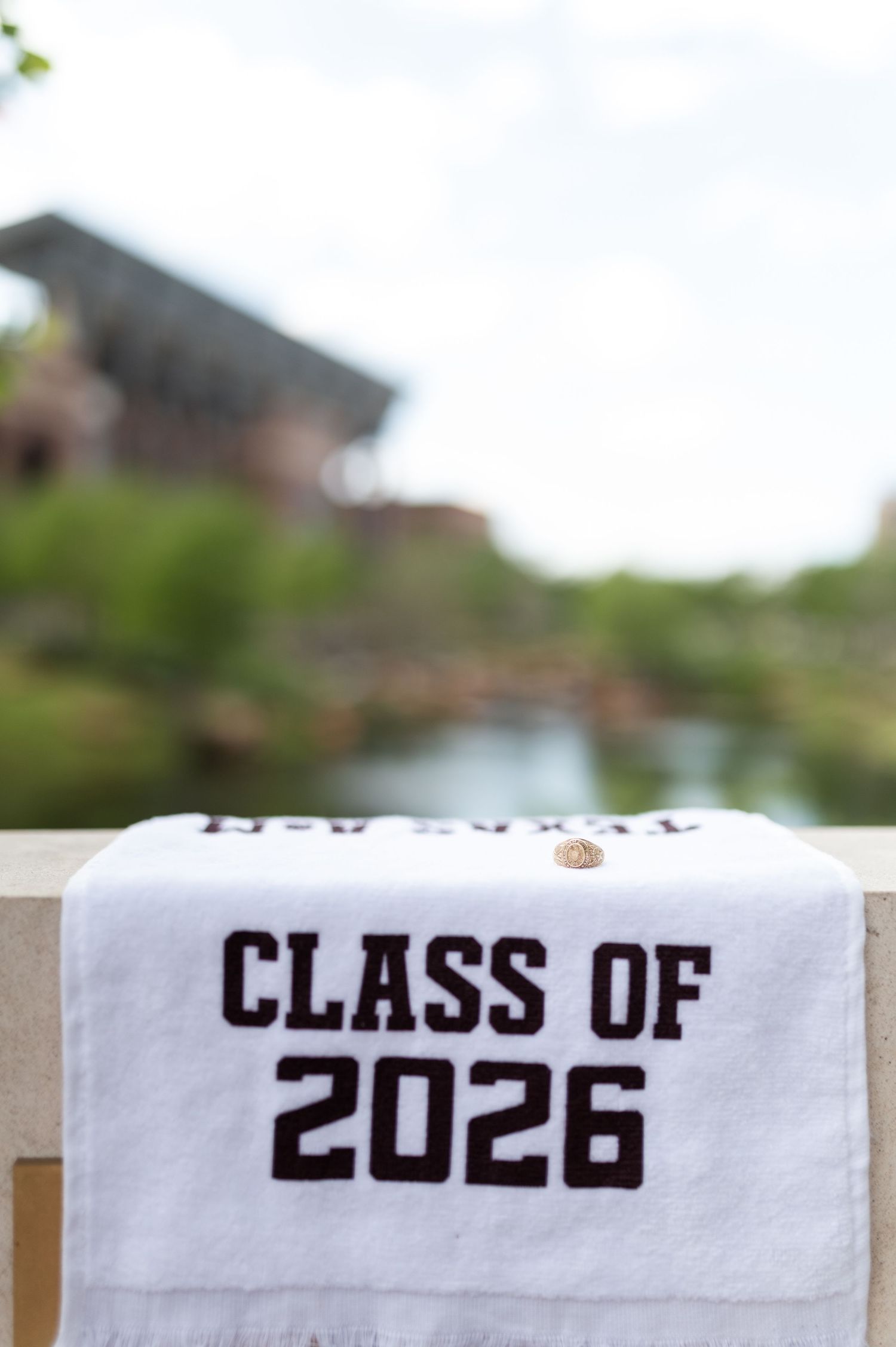 A white towel reading Class of 2026 draped over a railing outdoors.
