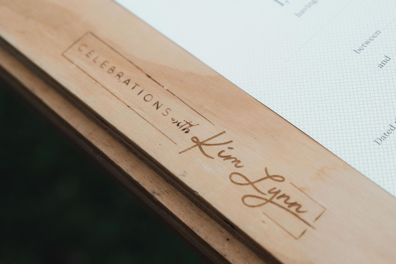 Wooden box engraved with Celebrations with Kim Lynn logo, elegant script branding for event planning services.