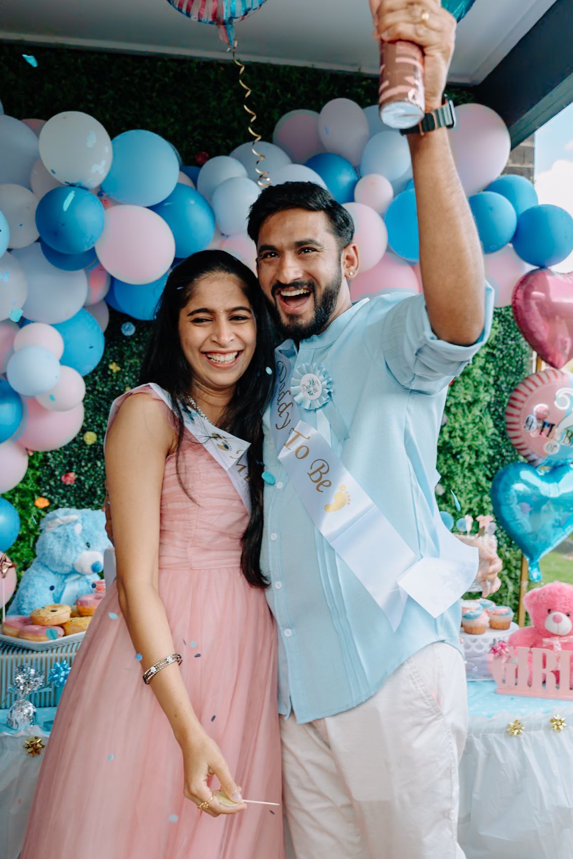 A gender reveal party decorated with pink and blue balloons and festive decorations.