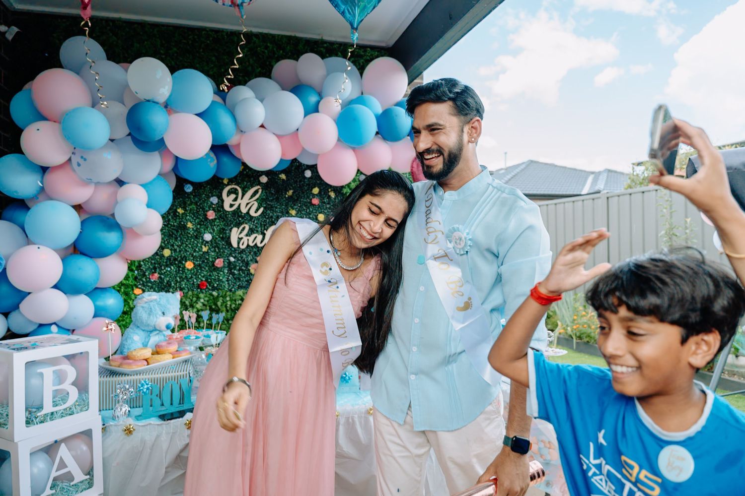 Festive party scene with balloon garlands in pink and blue colors.