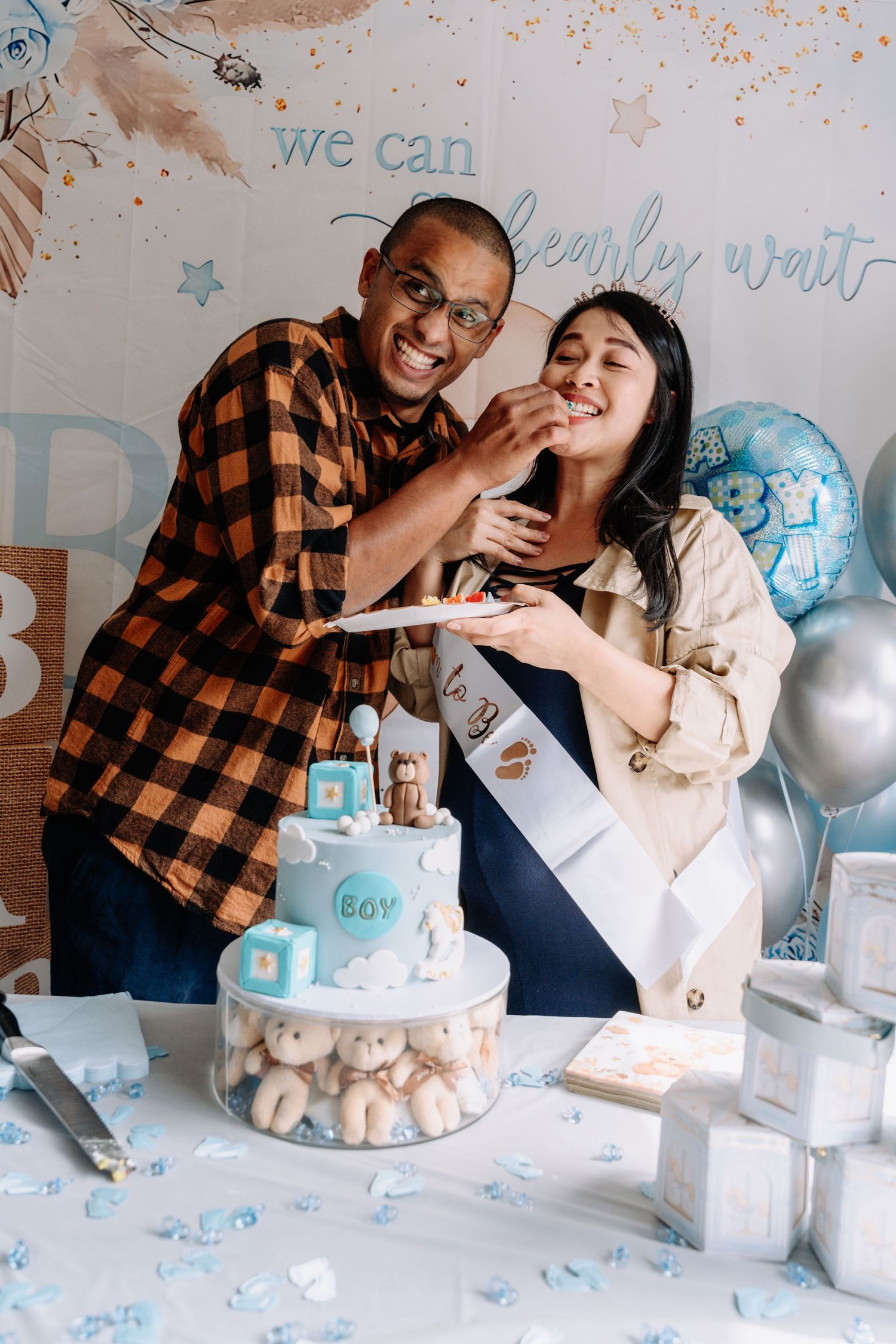 A series of four photos showing a gender reveal celebration with a cake and blue balloons in a decorated room.
