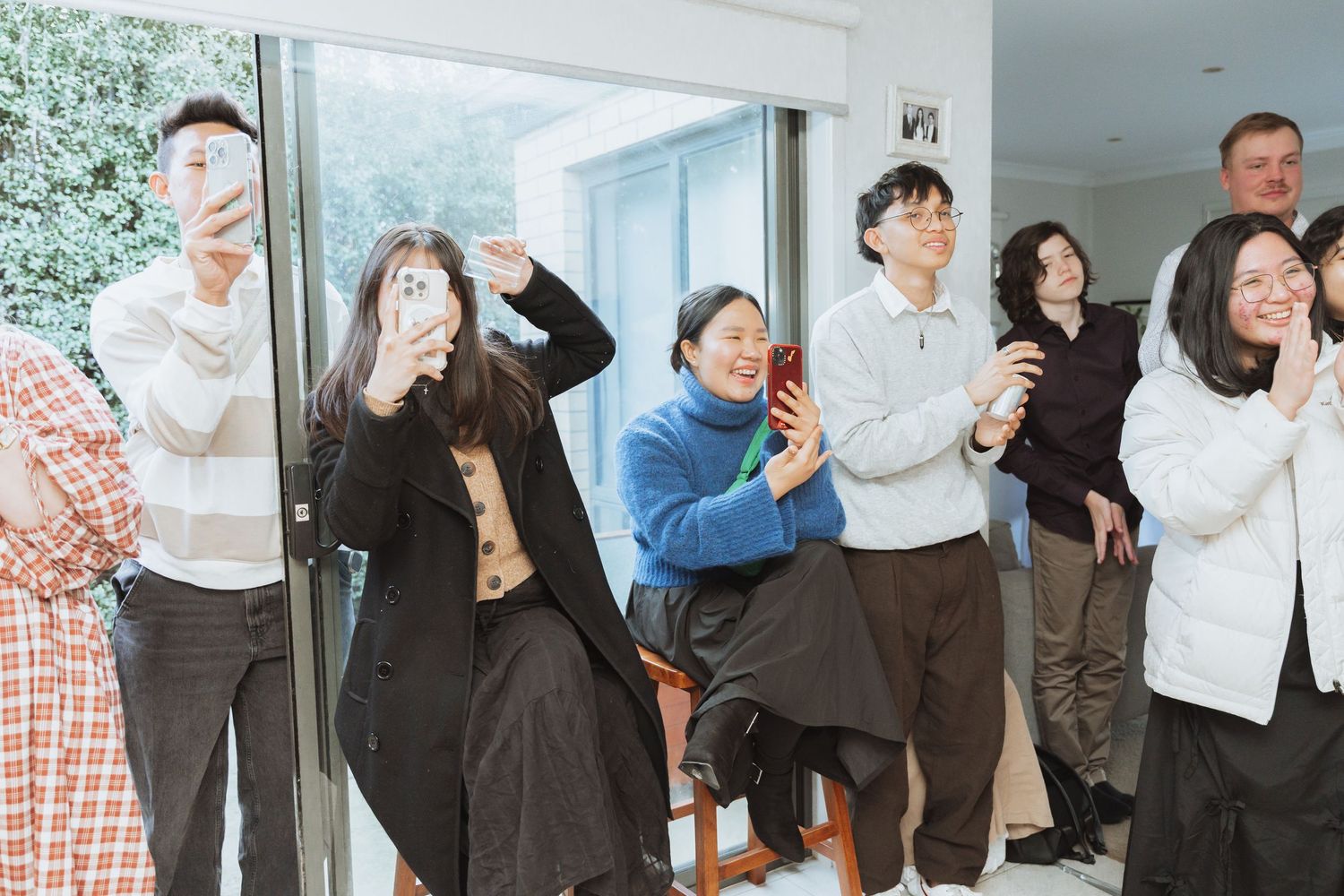 People hugging and showing emotion during what appears to be a celebratory gathering indoors.