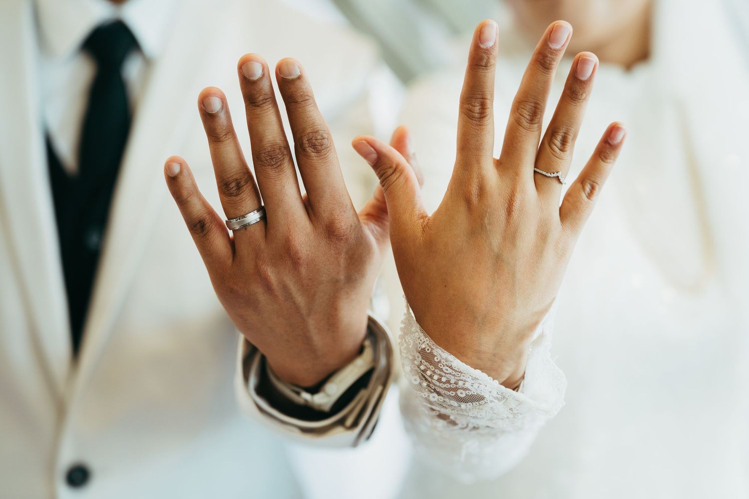 Close-up detail shots of hands wearing wedding rings in sequence showing different angles and poses.