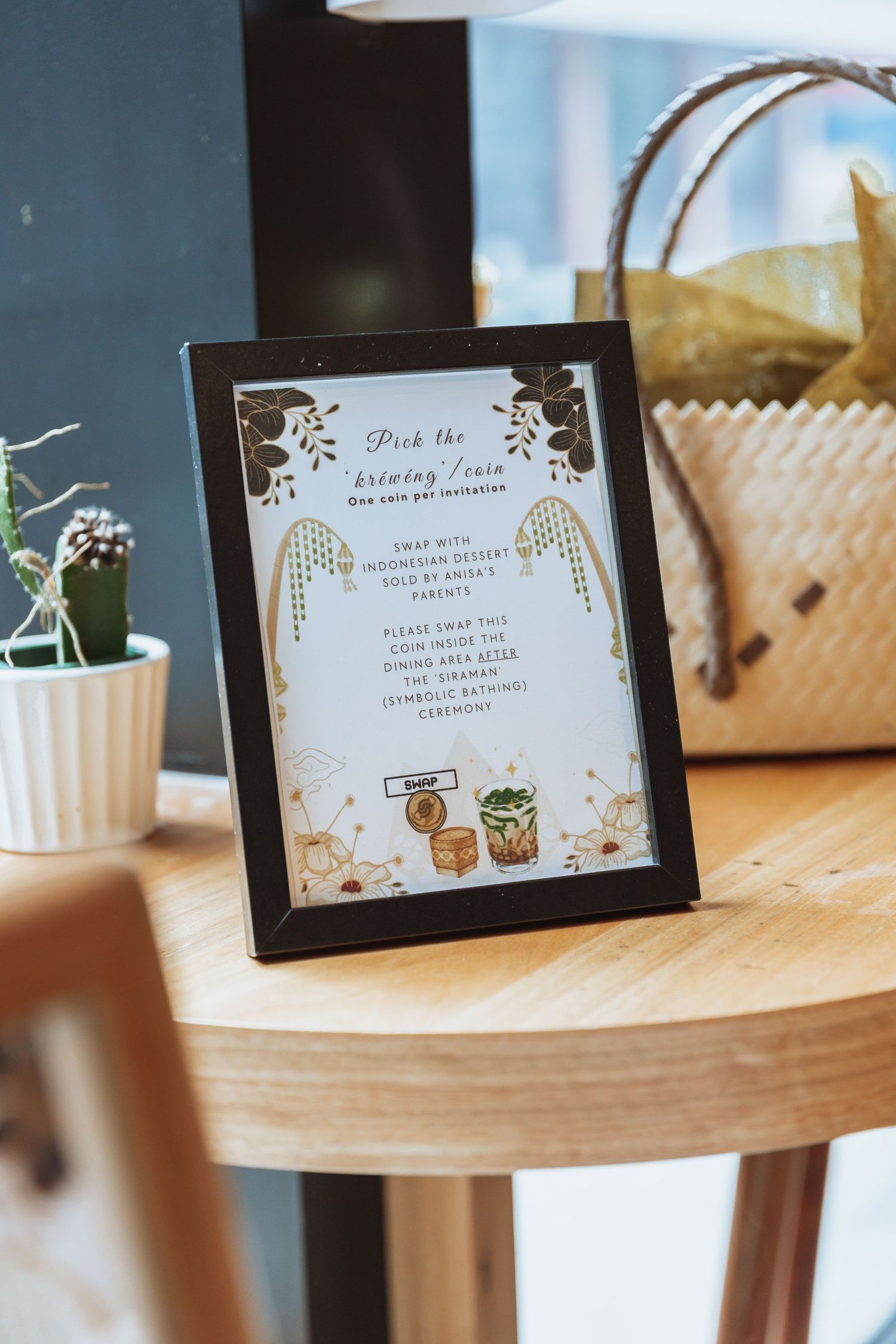 Elegant wedding table signs with floral designs and gold accents displayed on wooden surfaces.