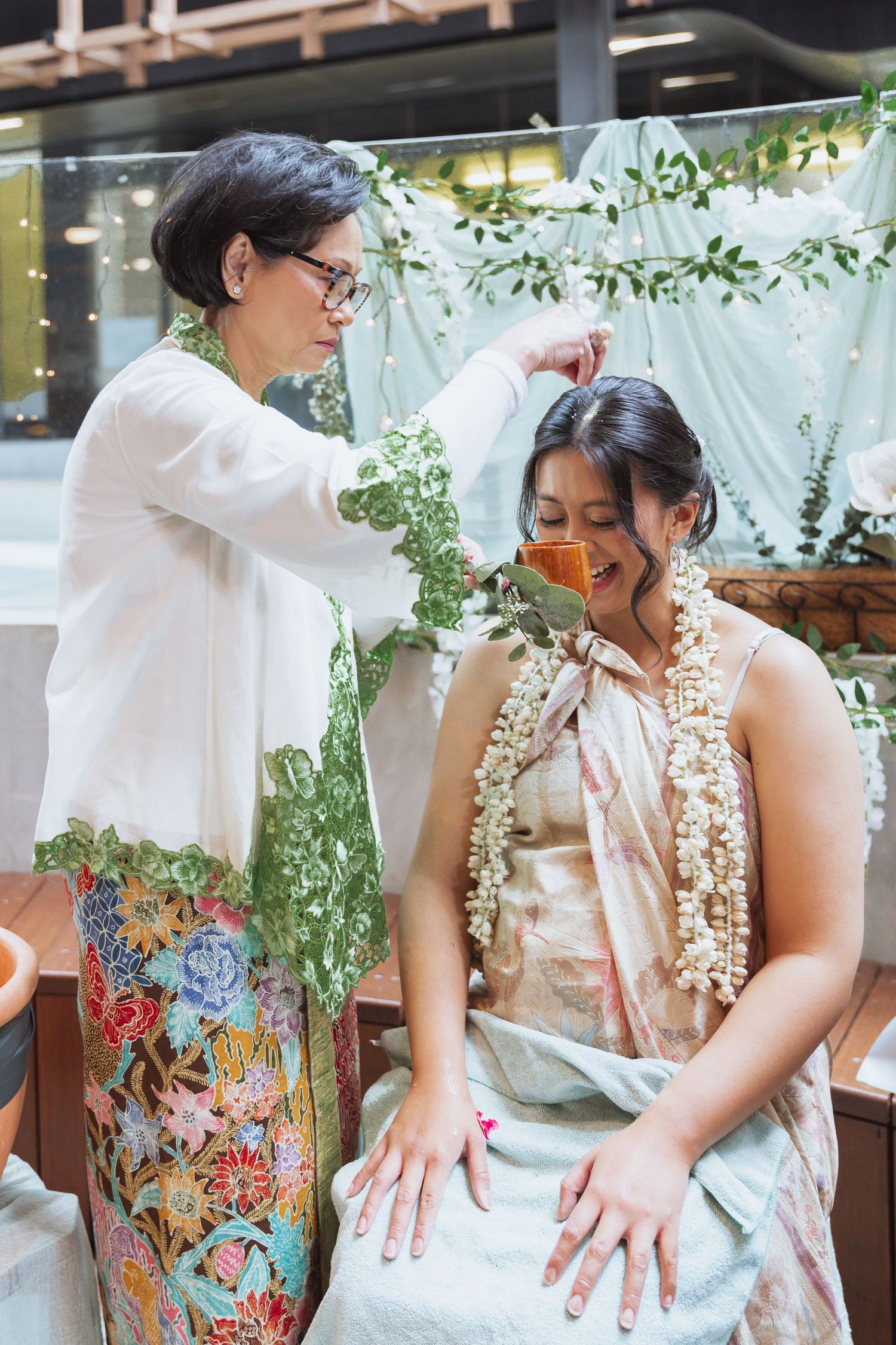 A sequence of photos showing hands adjusting and smoothing a floral patterned dress with delicate lace details.