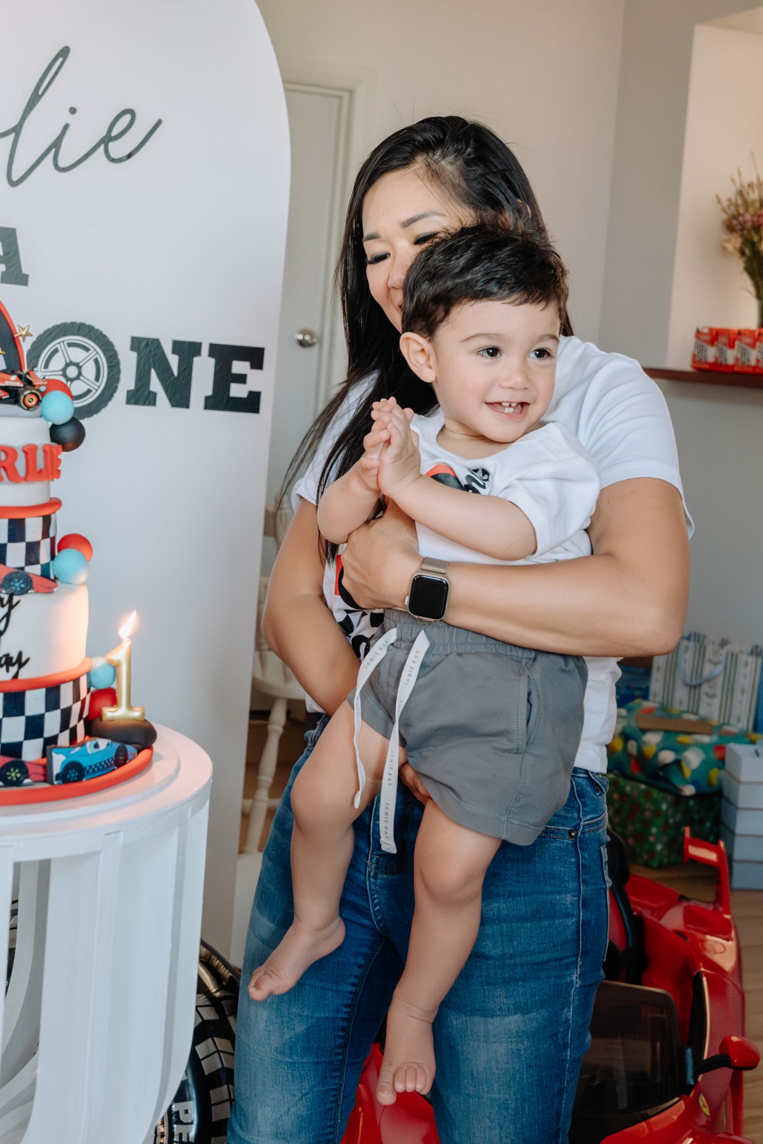 Birthday celebration scene with a racing themed cake and decorations.