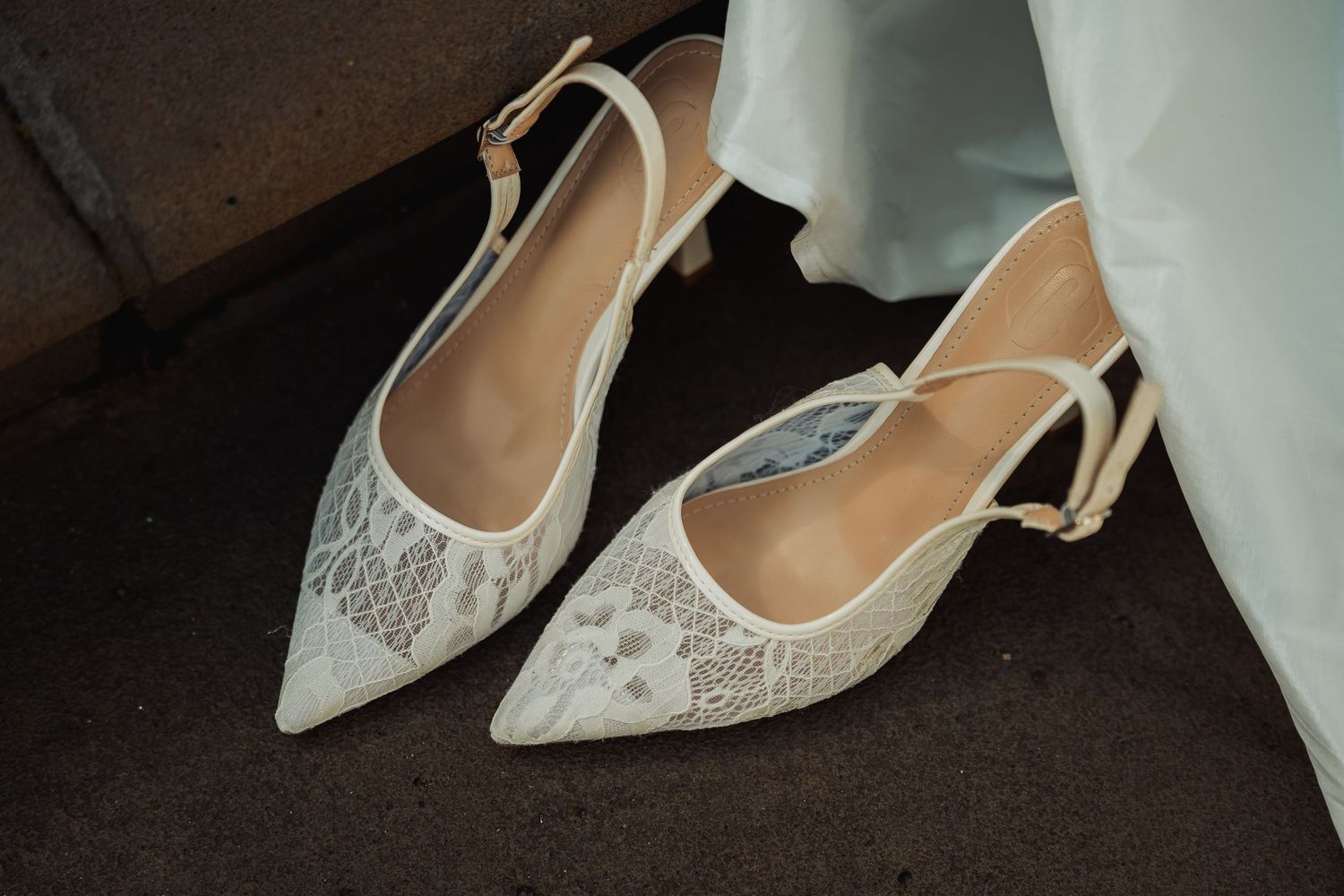 Elegant ivory lace slingback kitten heels with pointed toe and floral embroidery, perfect bridal wedding shoes.