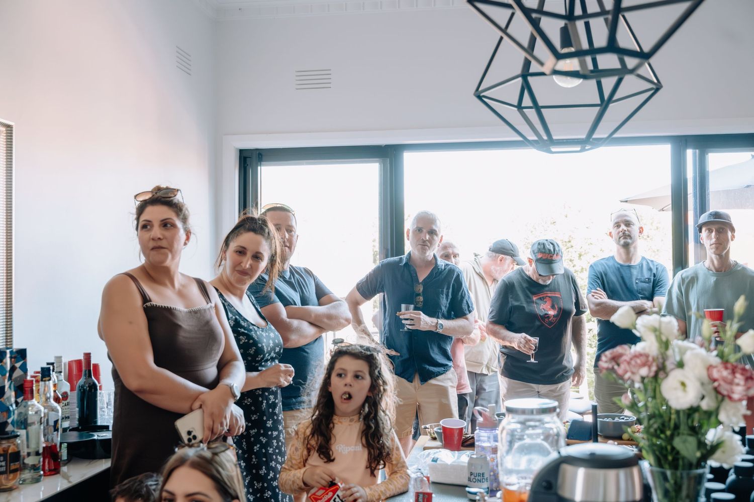 Group of people gathered around a table during a social event.