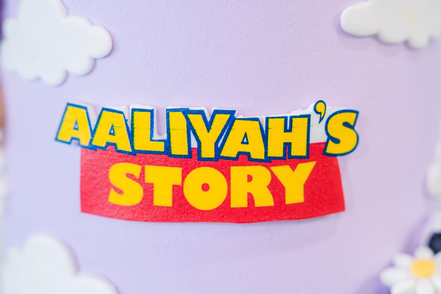 Colorful text reading 'AALIYAH'S STORY' against a purple background with white cartoon clouds.
