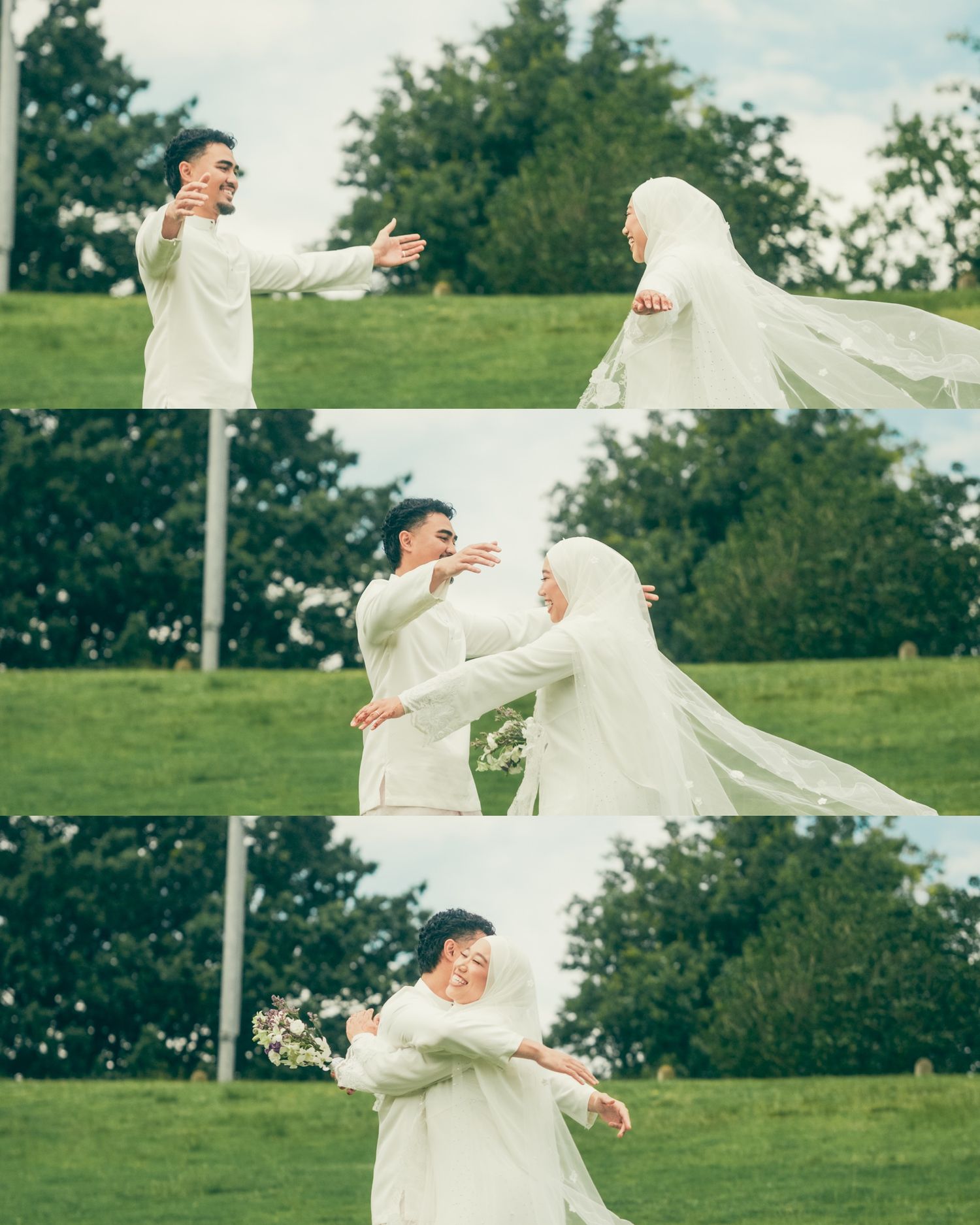 Muslim couple in white wedding attire embracing outdoors on green grass, bride wearing hijab veil flowing in wind.