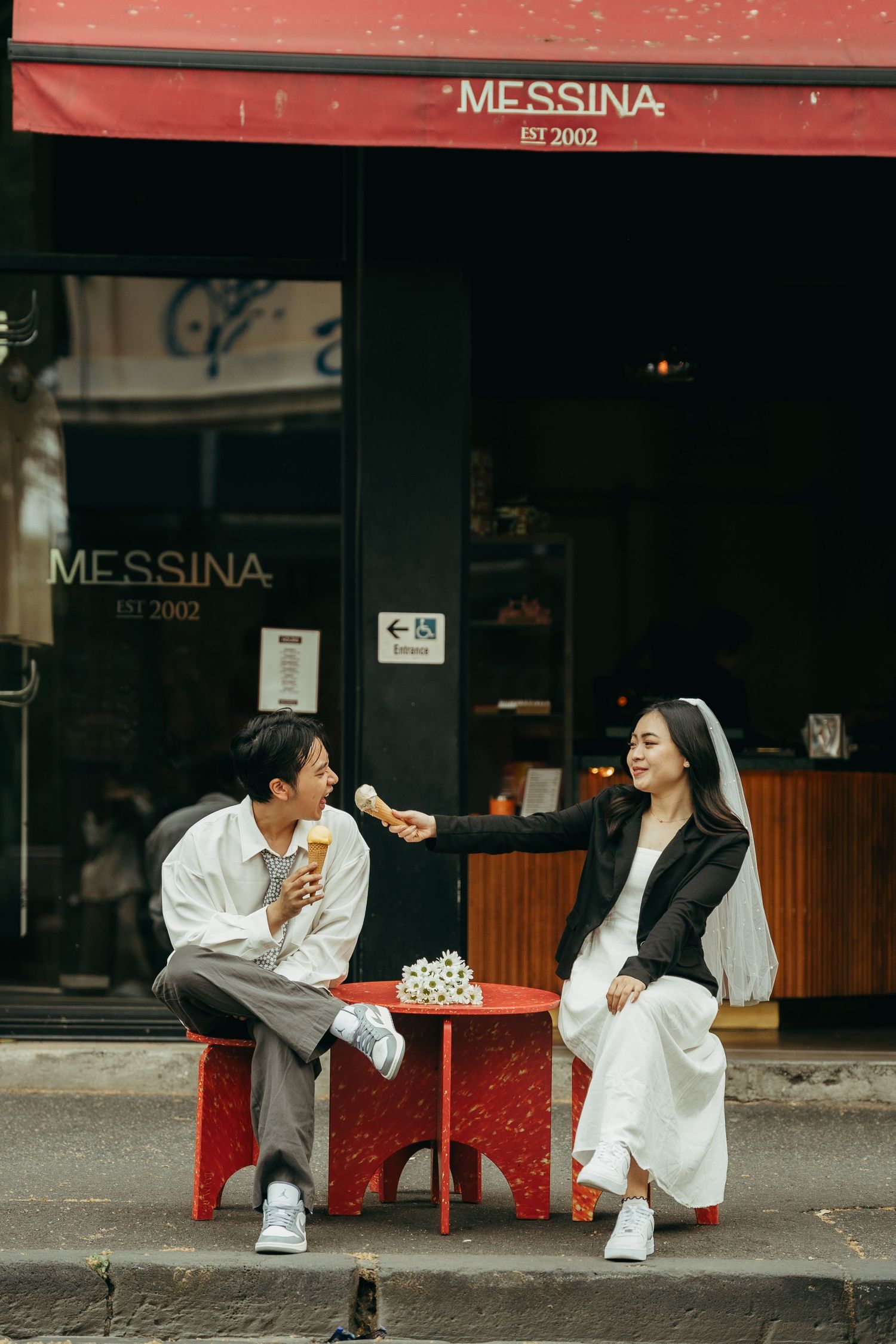Casual photoshoot outside Messina cafe with playful poses.