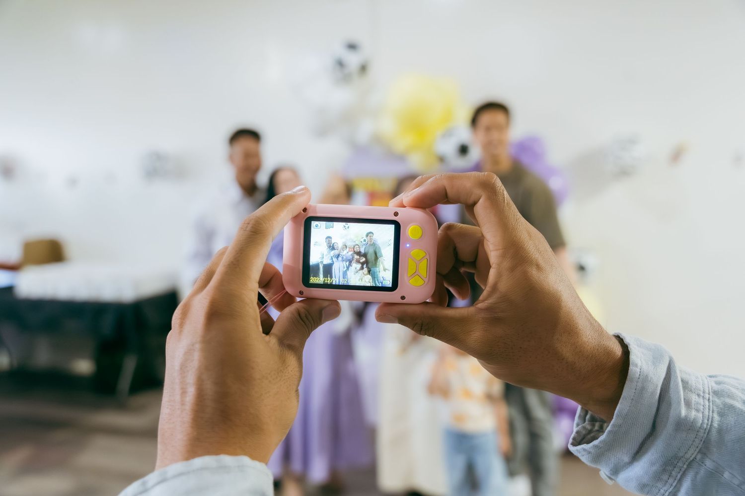 Someone holding a smartphone to take a photo of a presentation or meeting in a conference room setting.