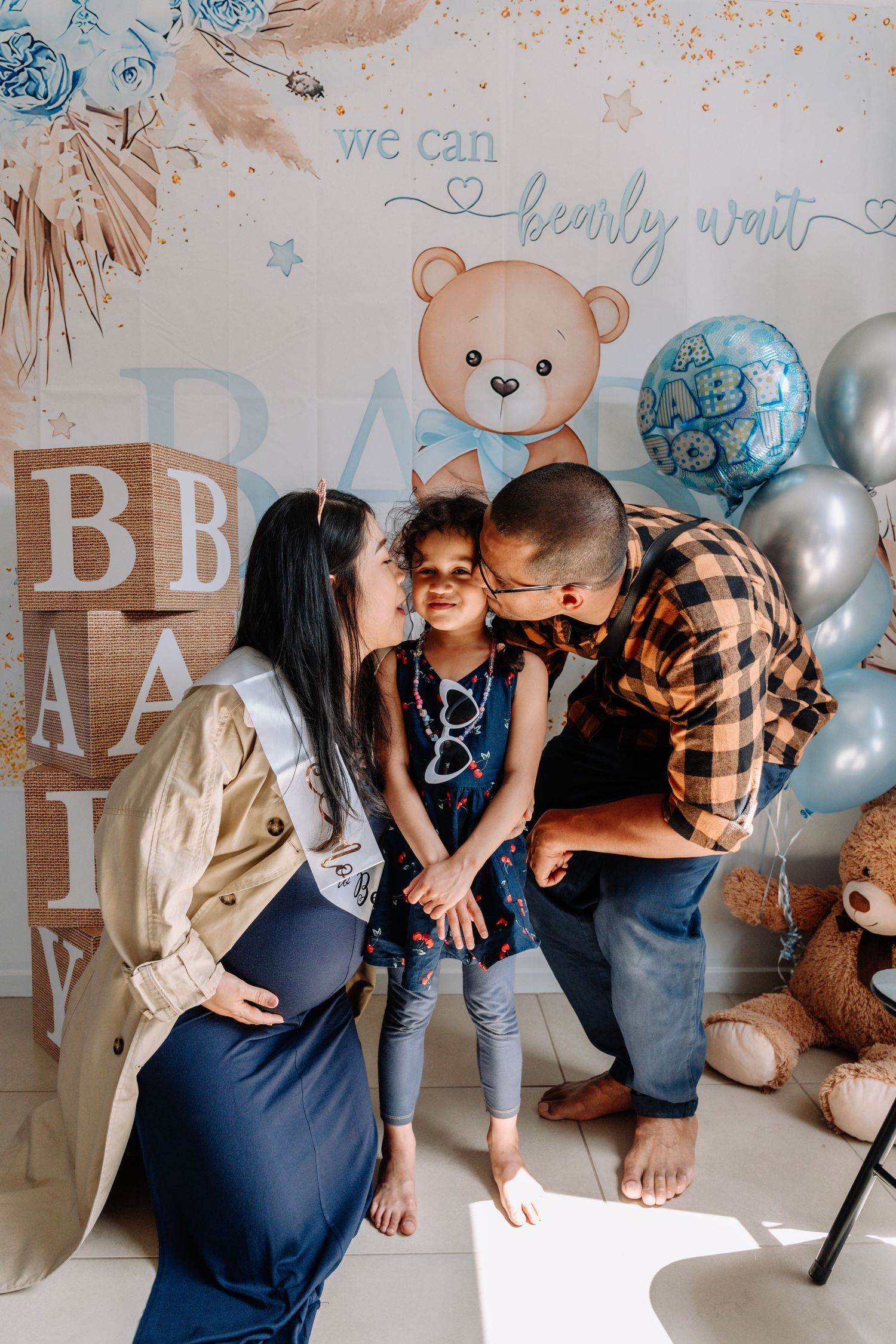 Baby shower celebration with blue balloons and teddy bear decorations.