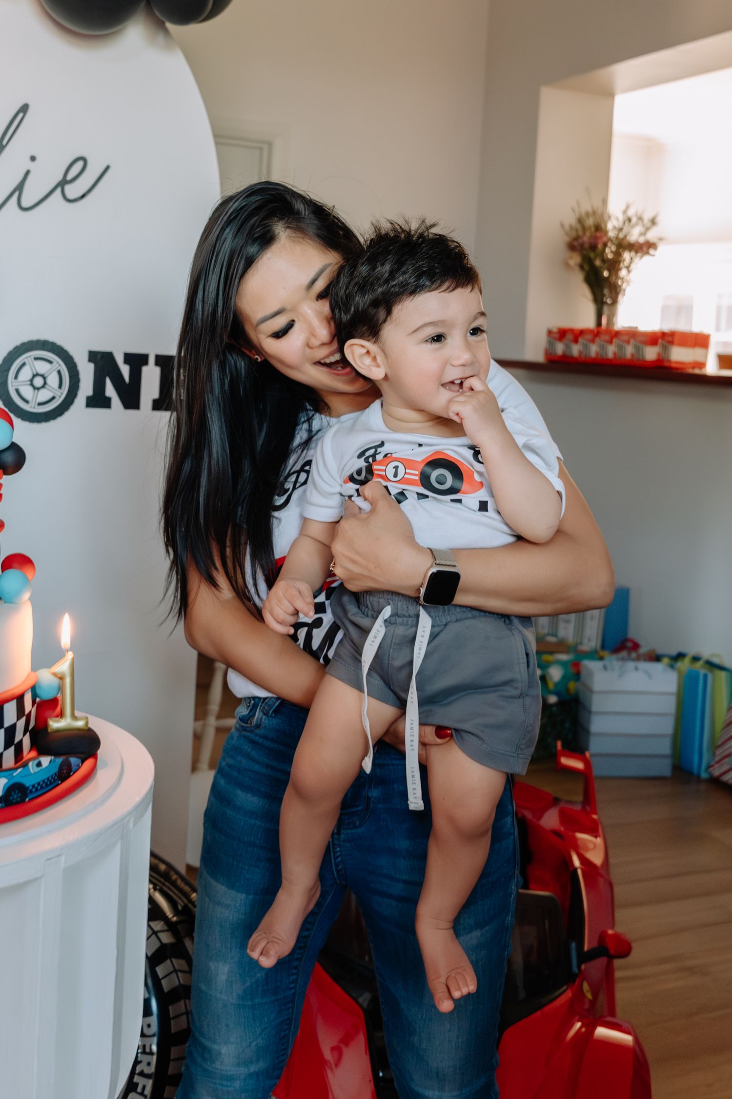 Birthday party celebration with racing theme decorations and balloons.