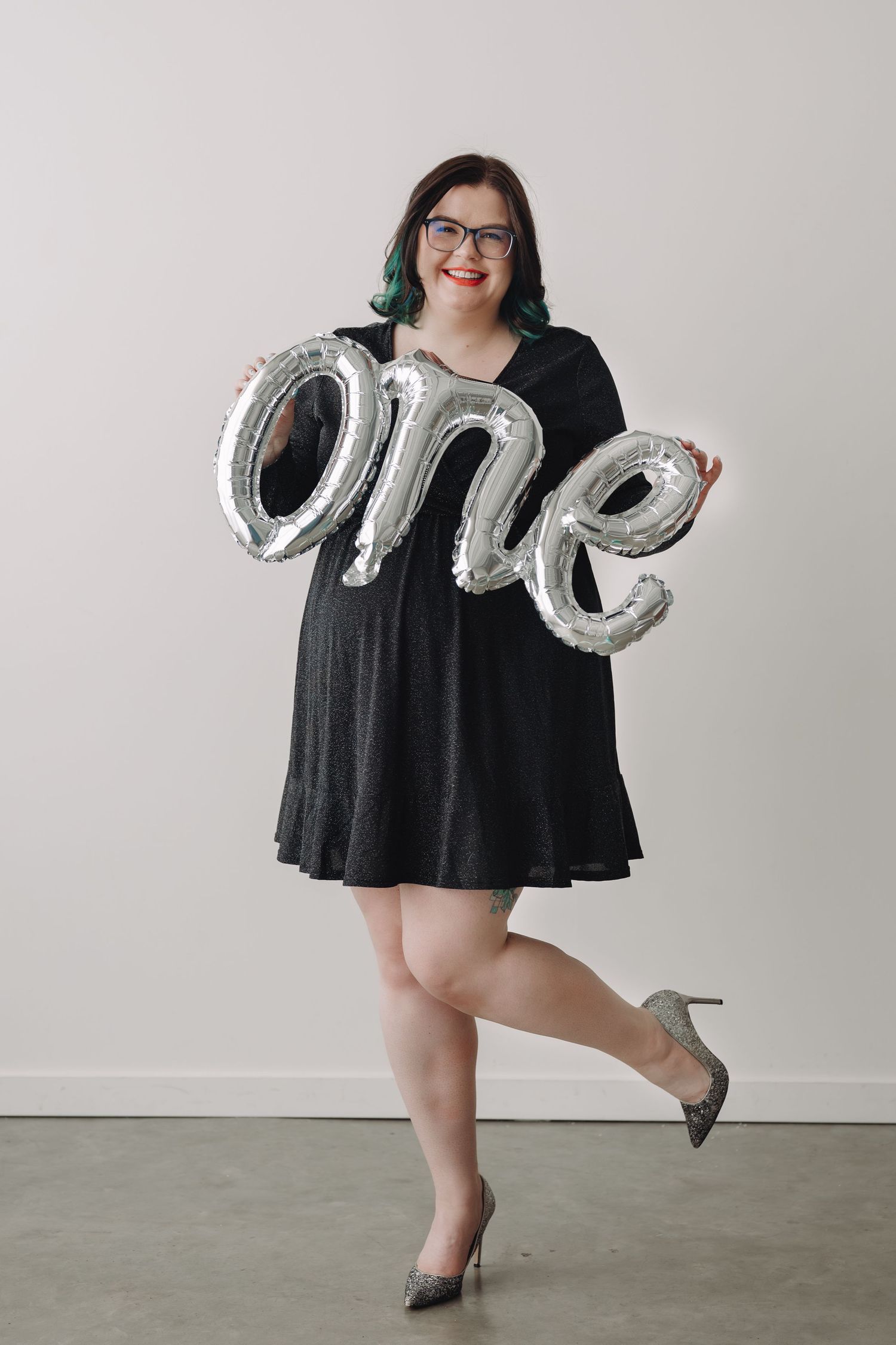 Woman in black dress holding a silver 