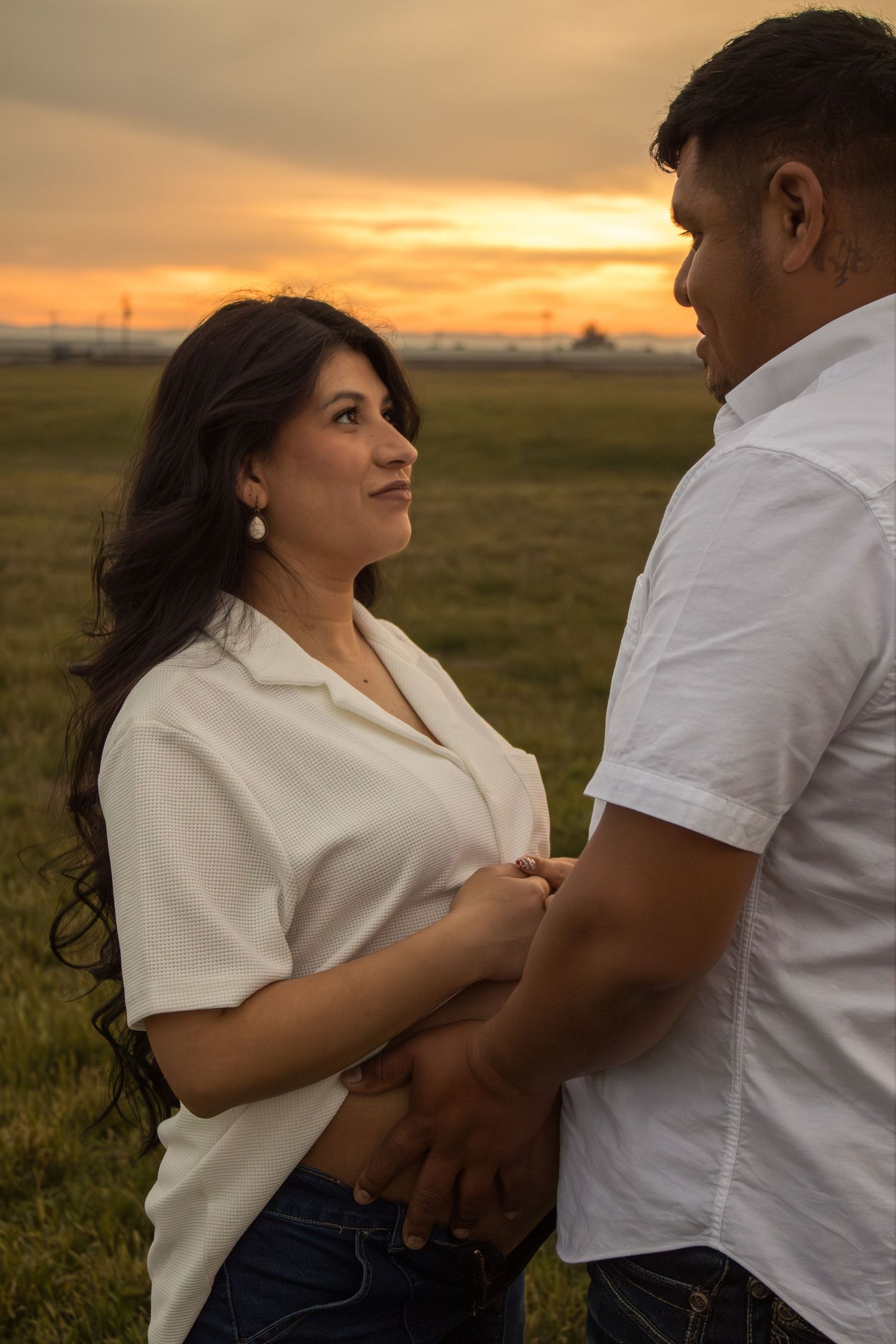 Maternity couple candid portrait during golden hour