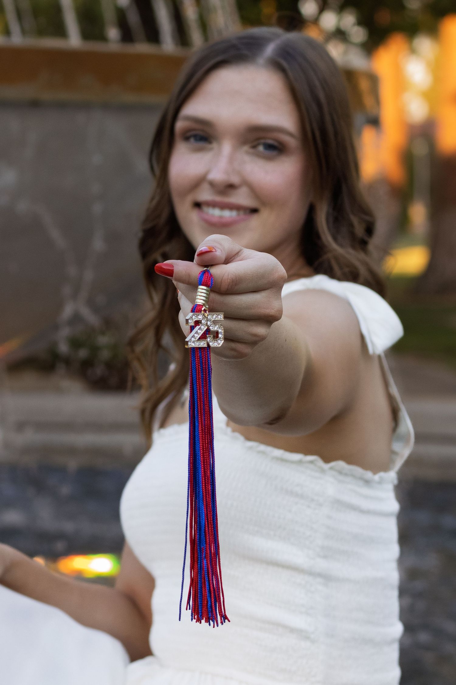 Candid graduation tassel details photographed during golden hour