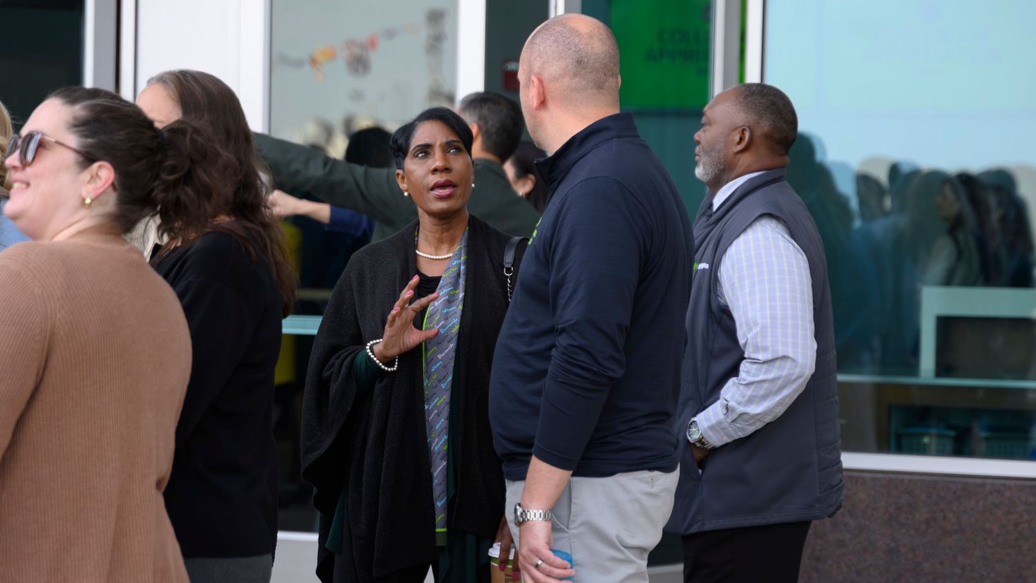 A diverse group of professionals engaged in conversation outside the cleveland browns statdium