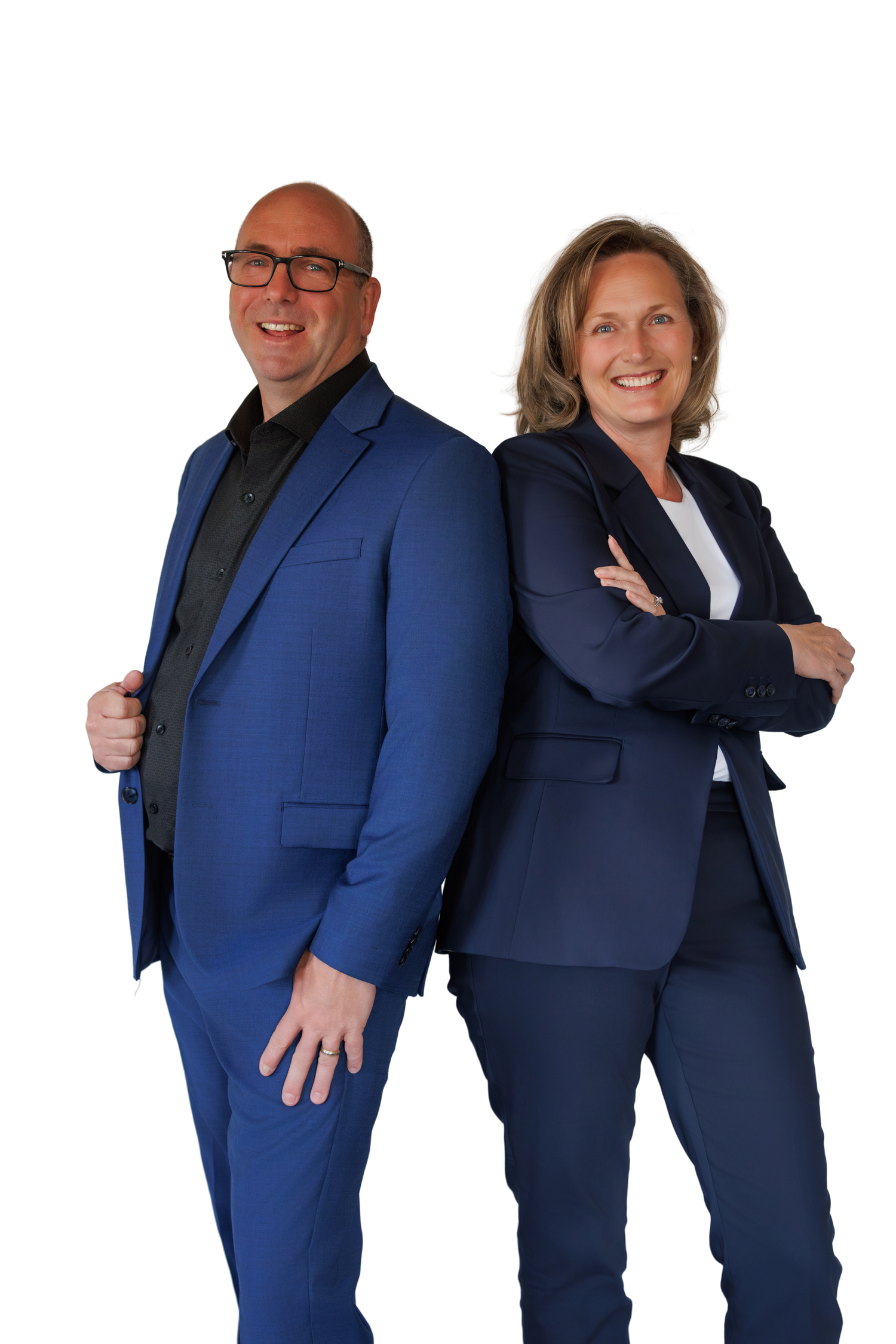Two professional real estate agents in blue suits posing back-to-back against white background.