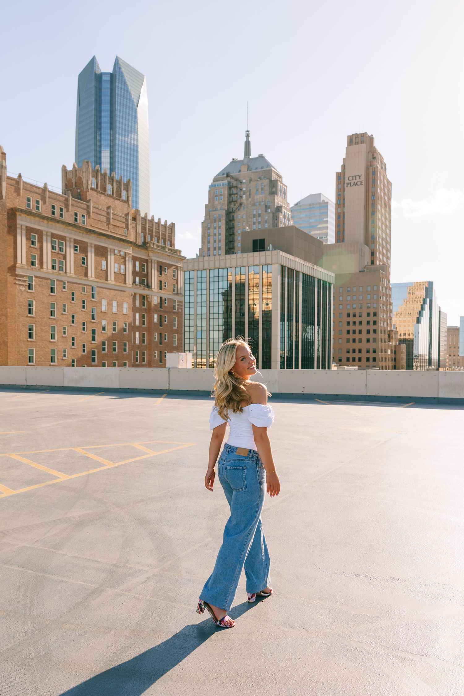 Urban rooftop scene with modern city buildings and skyscrapers in the background.