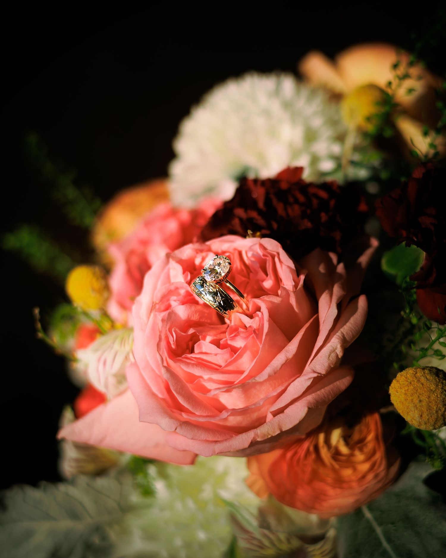 Close-up detail of pink roses with soft petals against a dark background.