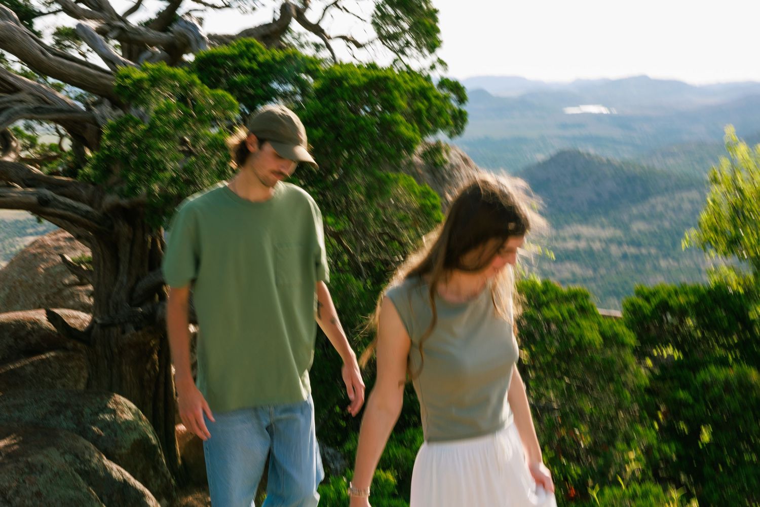 Scenic mountain overlook with distant hills and valleys stretching to the horizon.