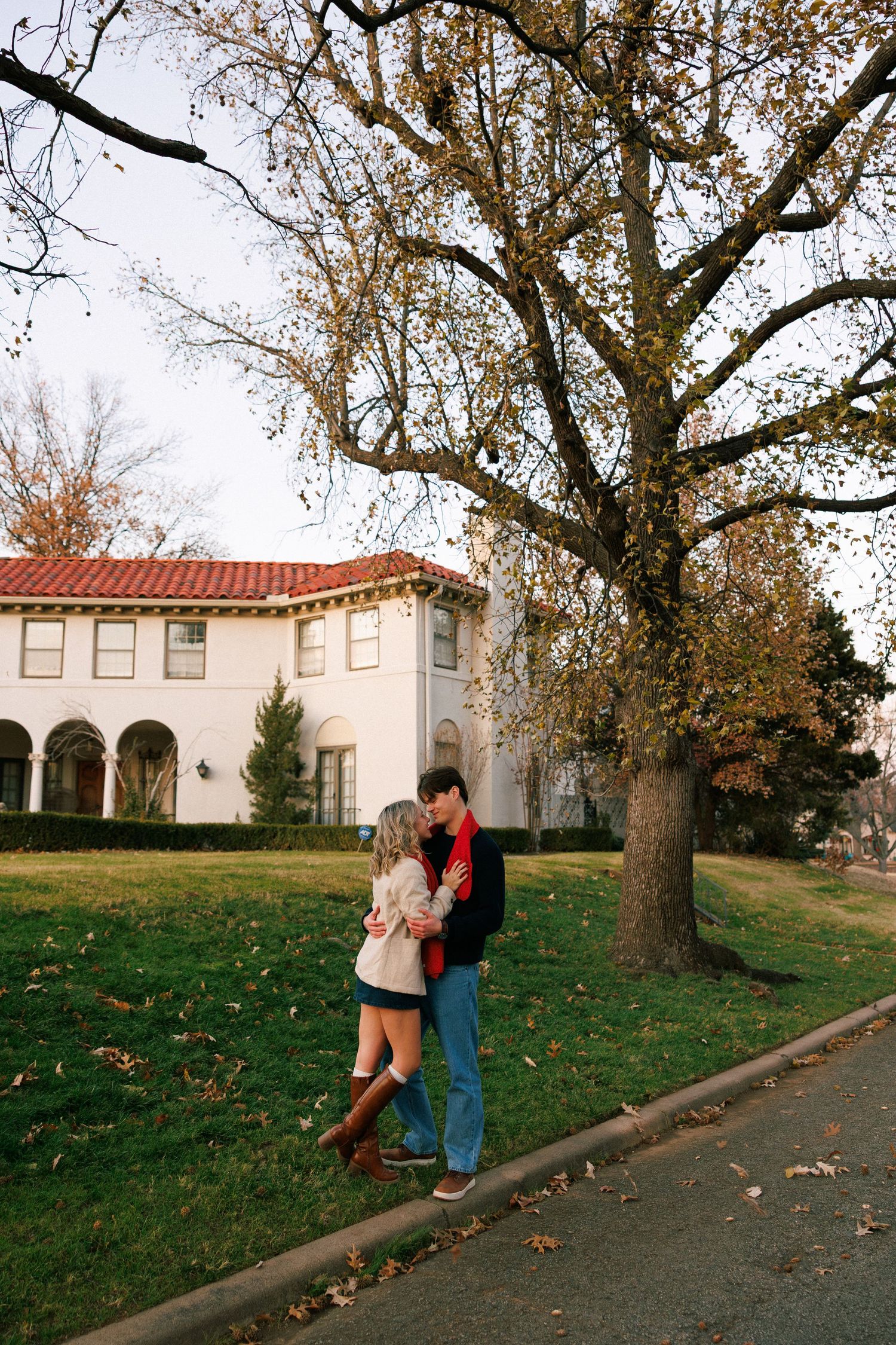 A romantic moment between two people by a Spanish colonial building on a fall afternoon.