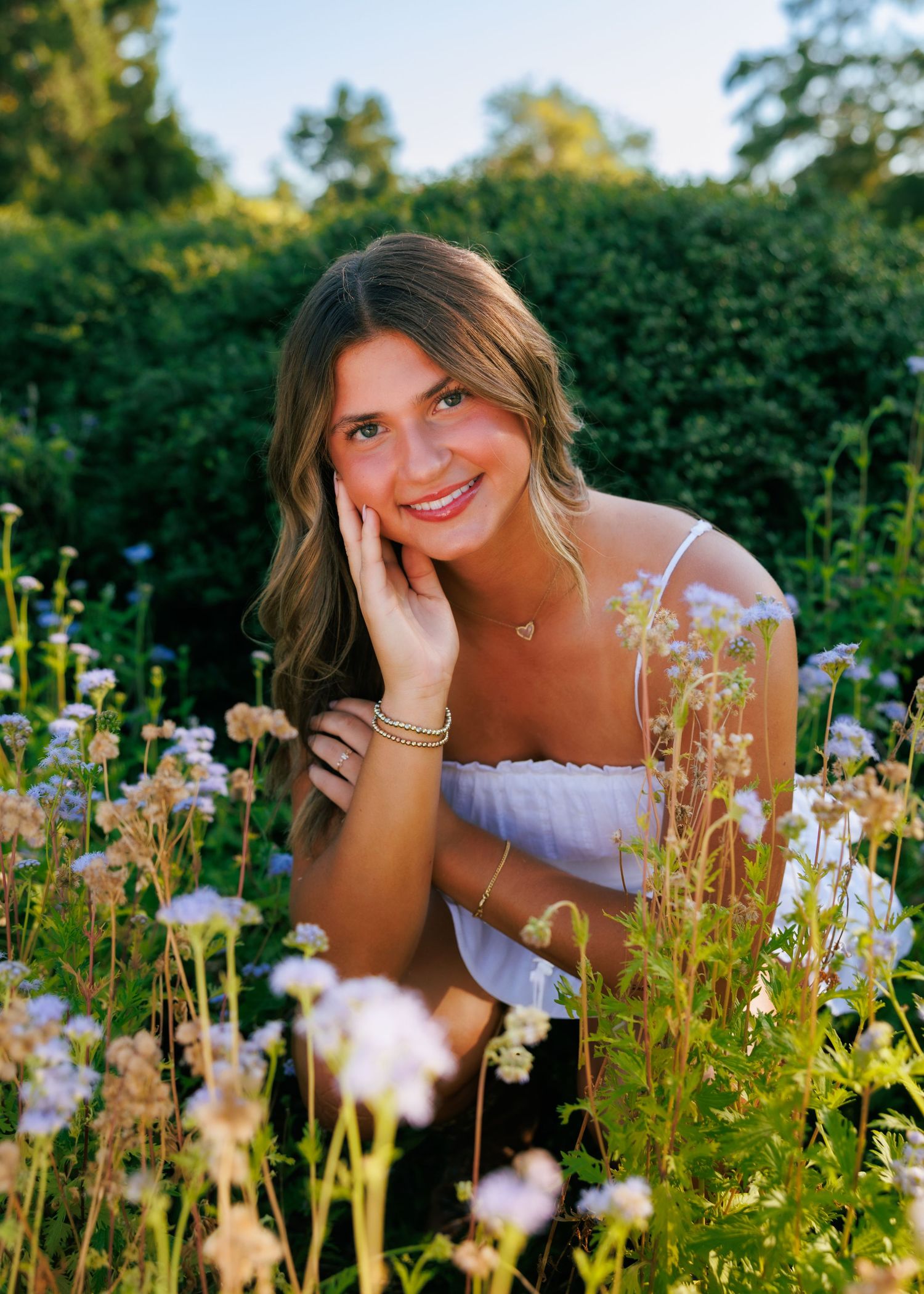 A summer garden scene with wildflowers blooming around a white sundress.