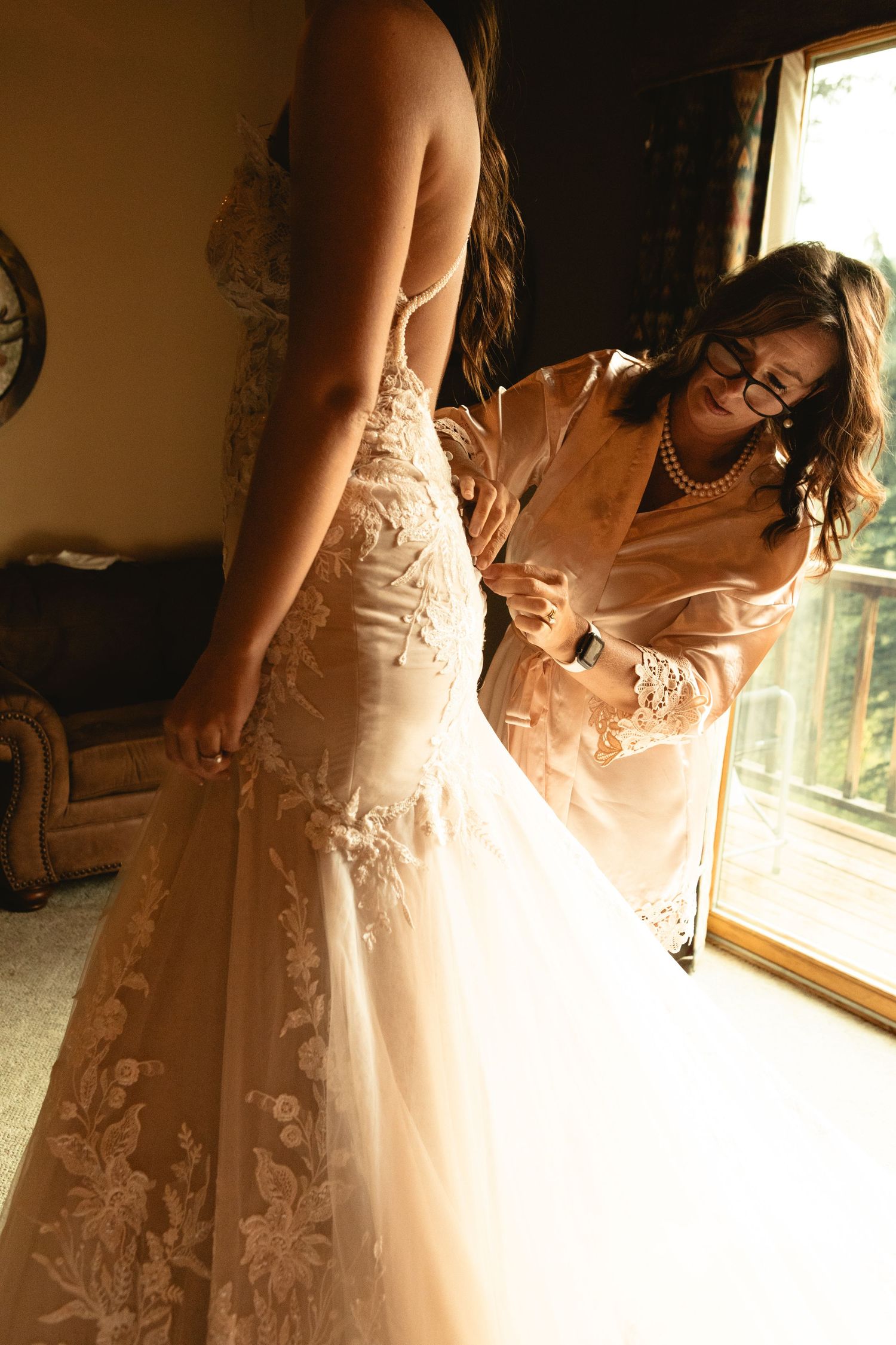 Mother of the bride sews bride into dress