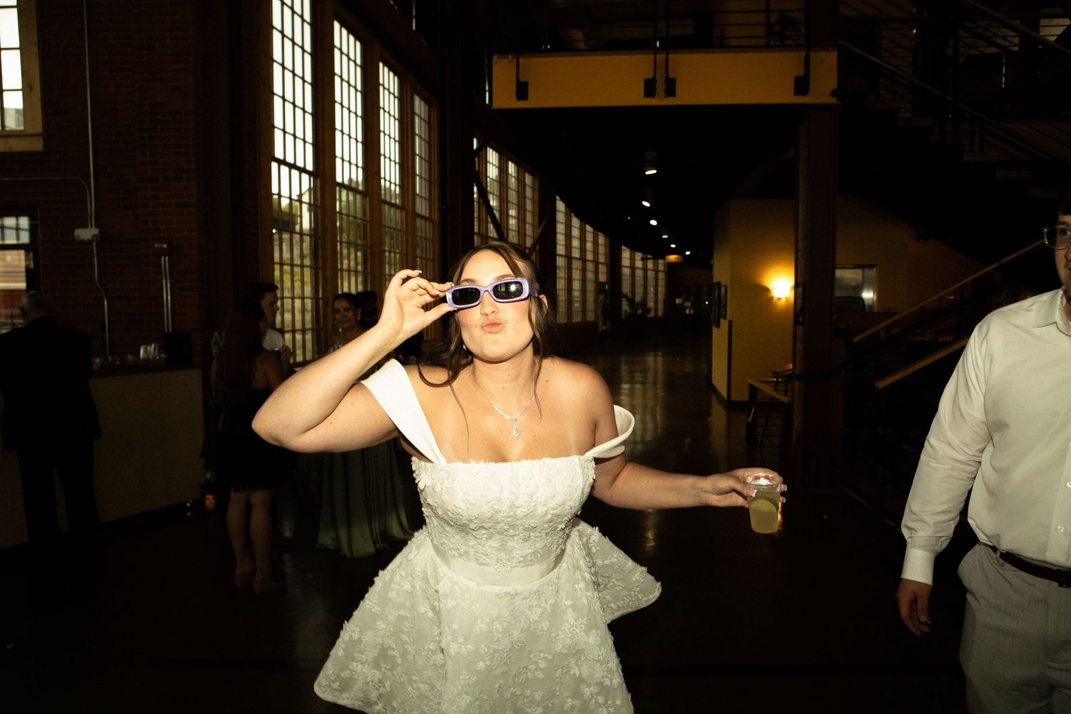 Bride blowing kiss to the camera with her favorite drink