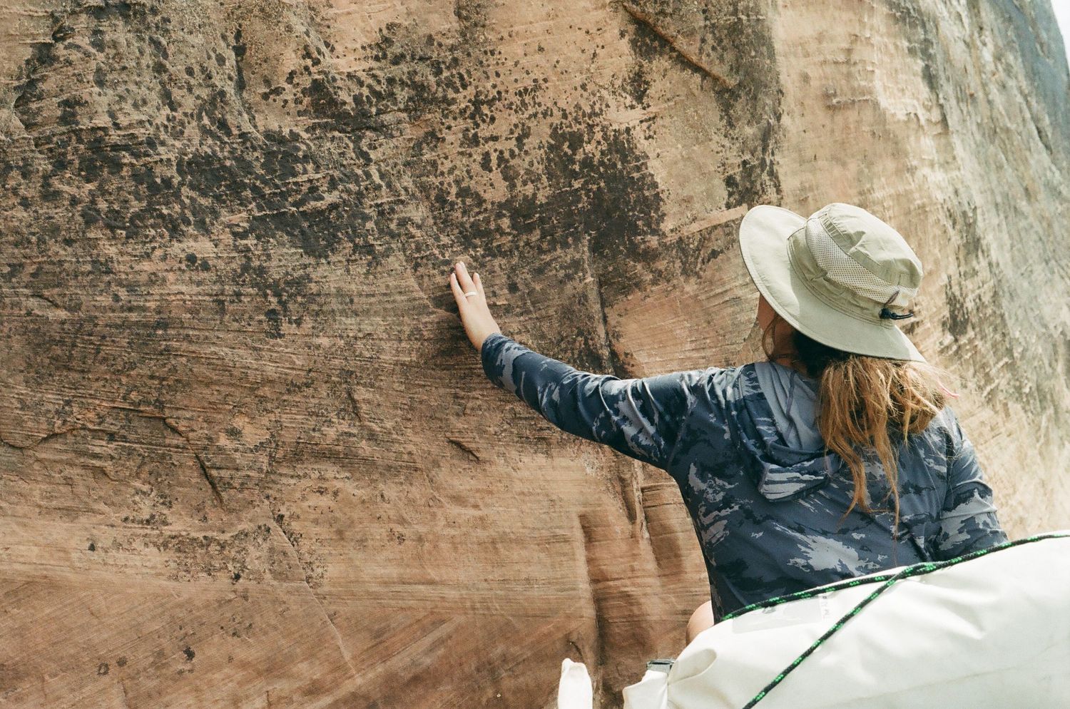 Touching giant red rock wall in Moab Utah