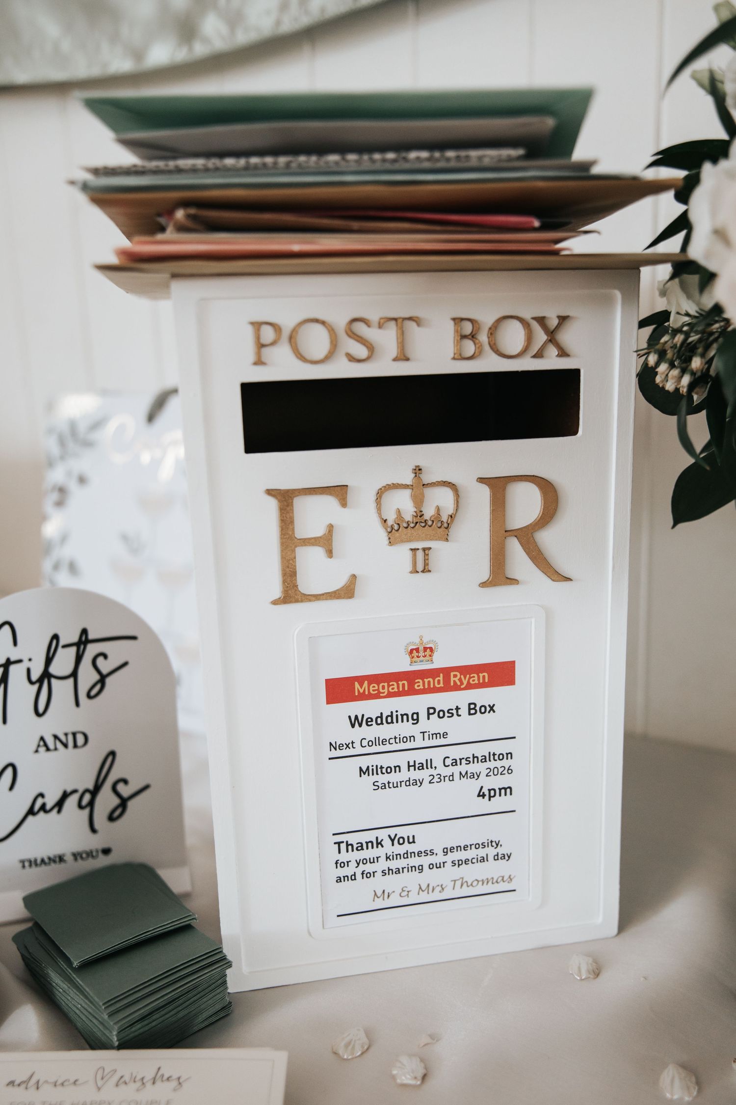 White wedding post box with gold ER crown monogram for Megan and Ryan at Milton Hall, Carshalton, May 2026.
