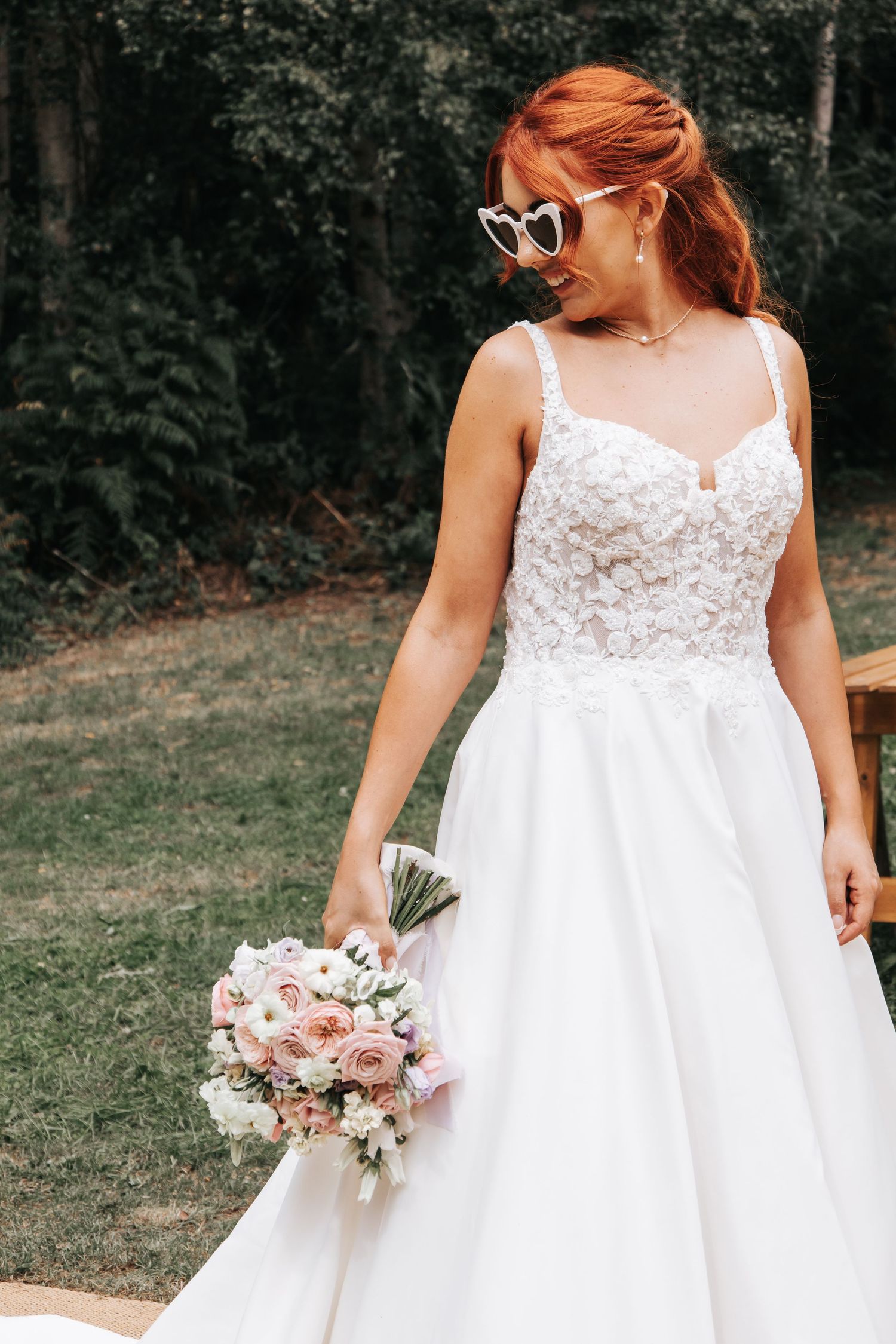 Classic white wedding dress with lace bodice and full skirt captured in outdoor setting.