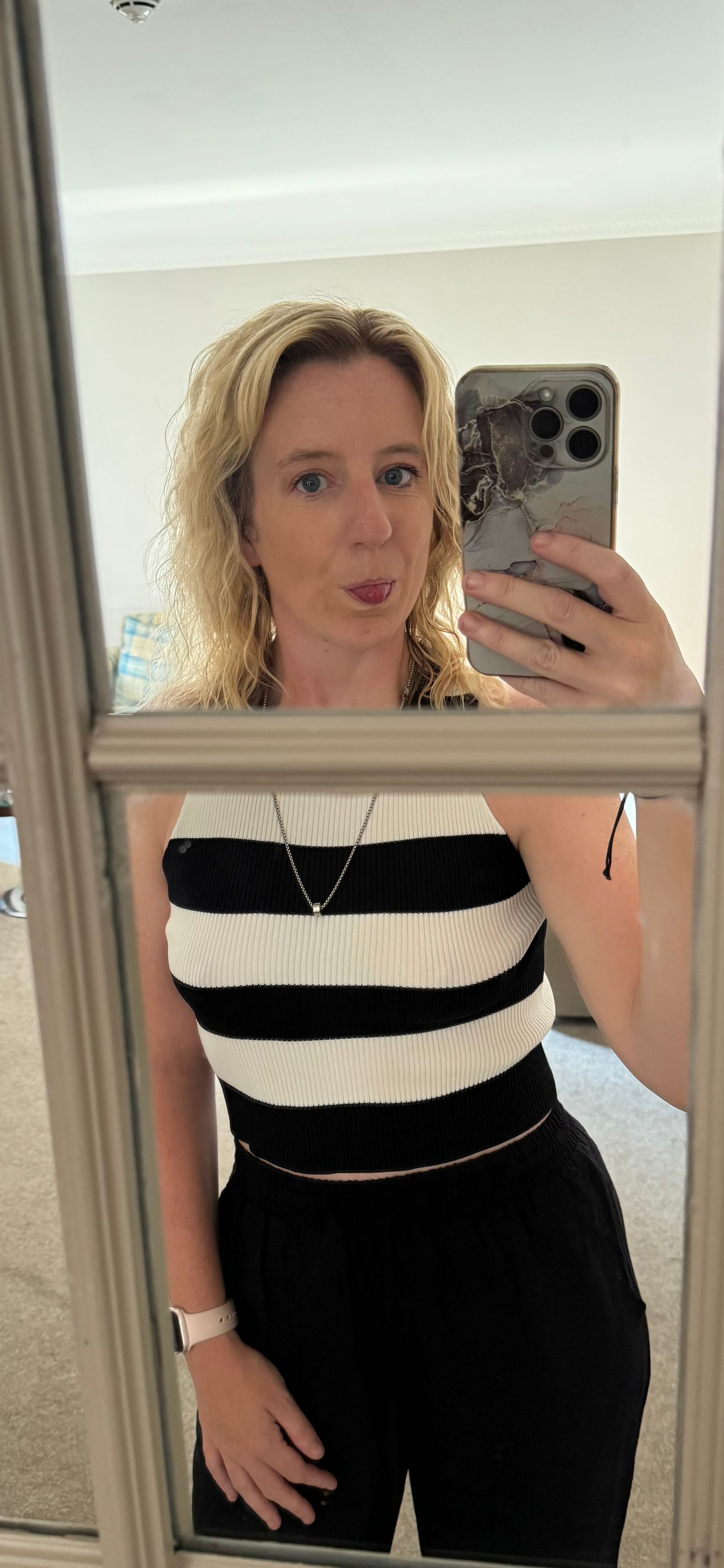 Mirror selfies showing a black and white striped sleeveless top outfit.