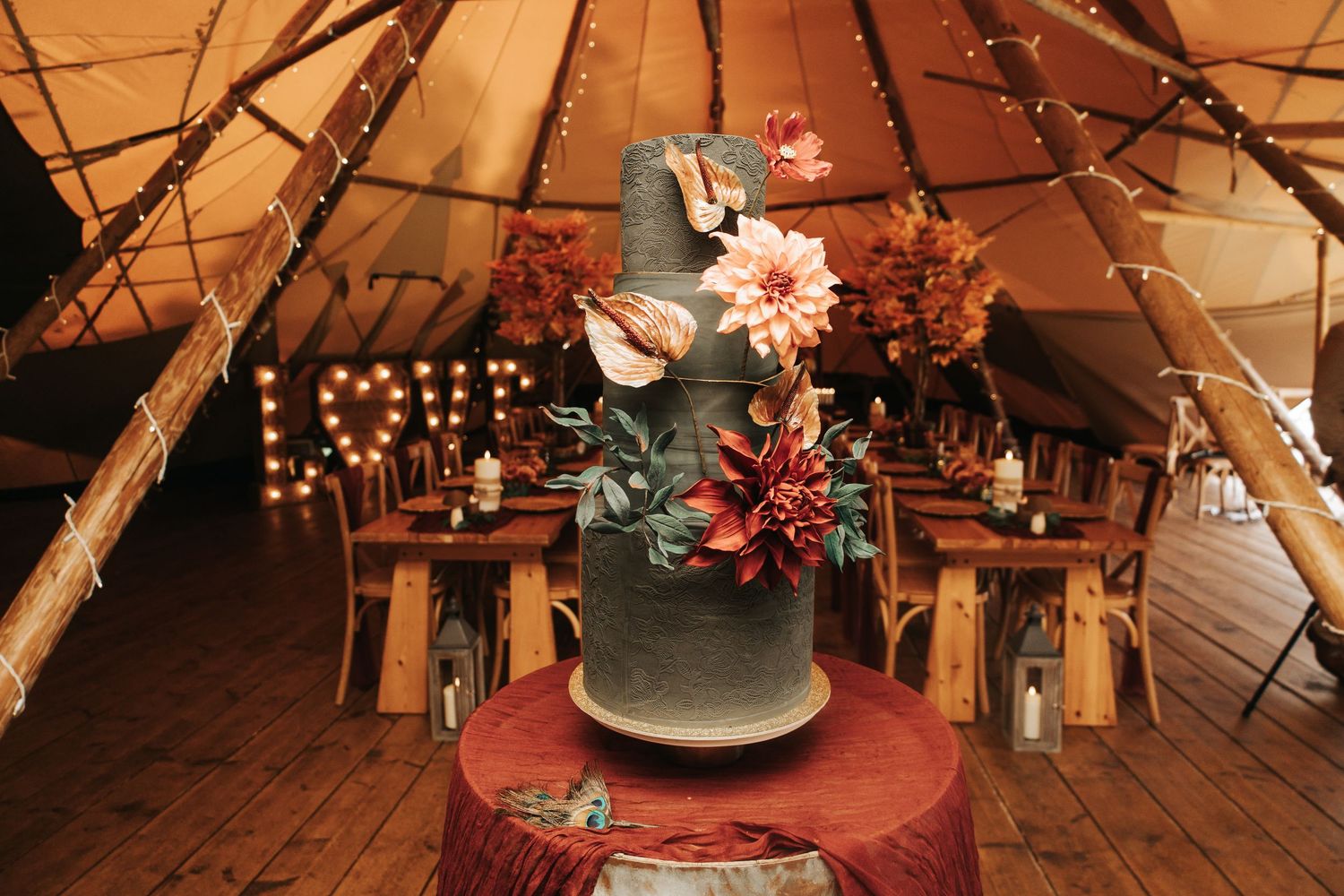 Rustic wedding venue interior with wooden beams and string lights creating a warm ambiance.