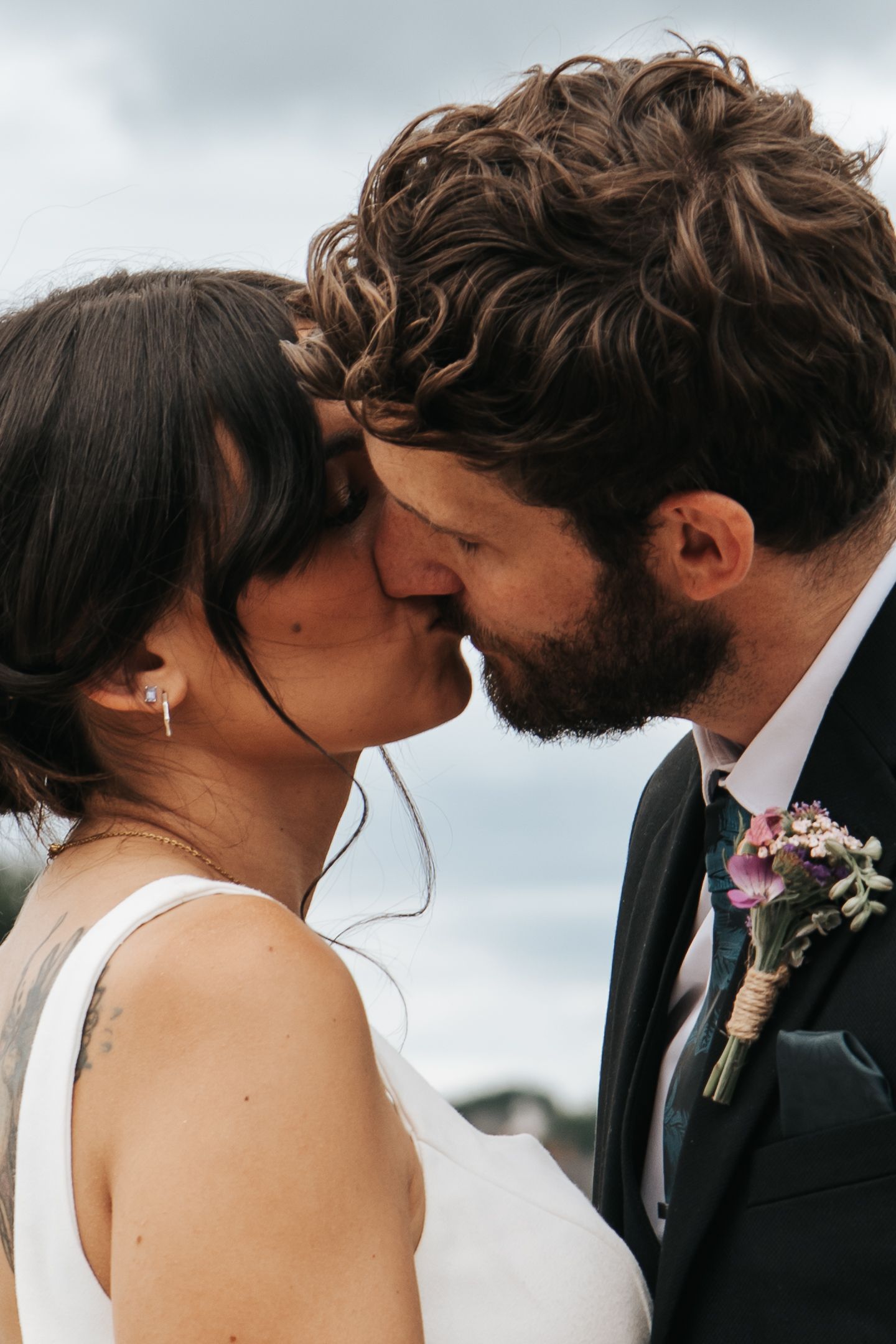 Intimate wedding portrait showing a tender embrace outdoors.