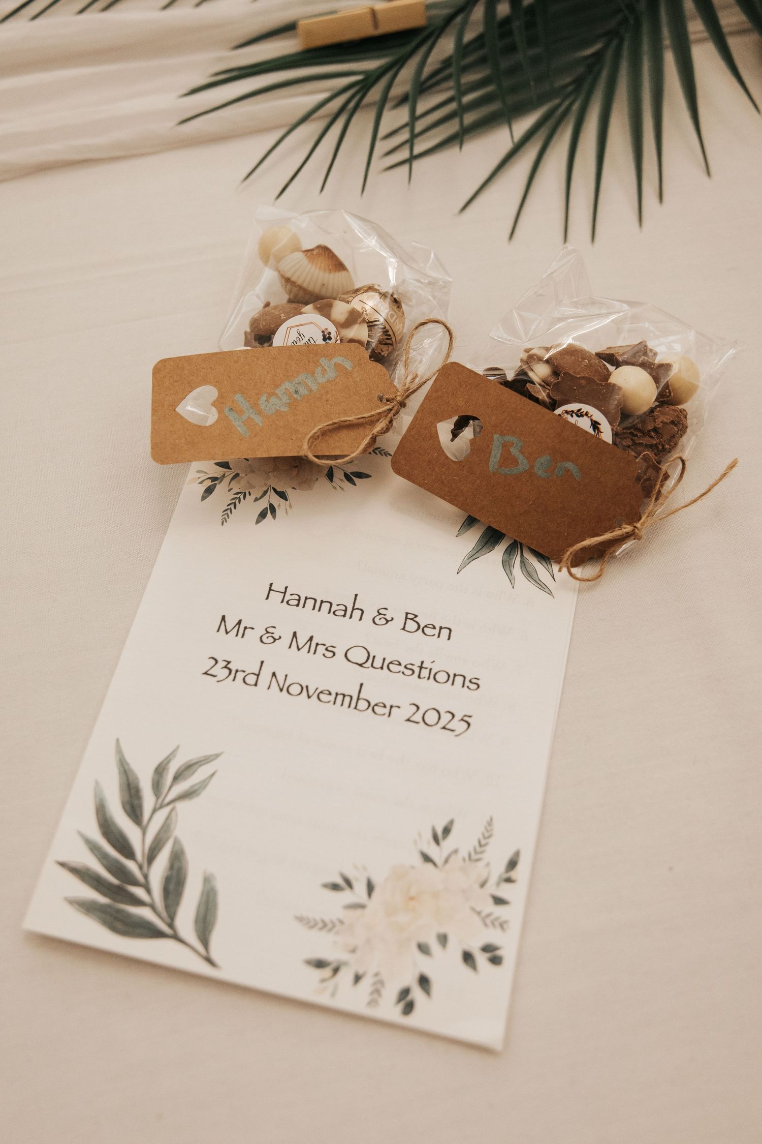 Rustic wedding place cards with botanical designs and wooden decorative elements.