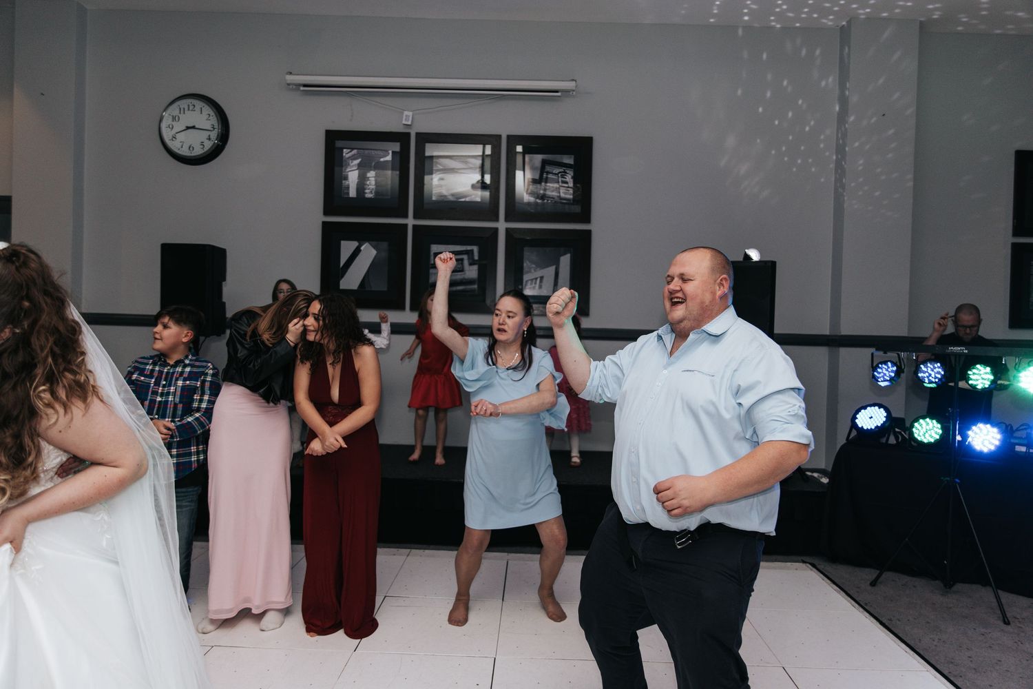 Reception guests enjoying themselves on the dance floor during a wedding celebration.