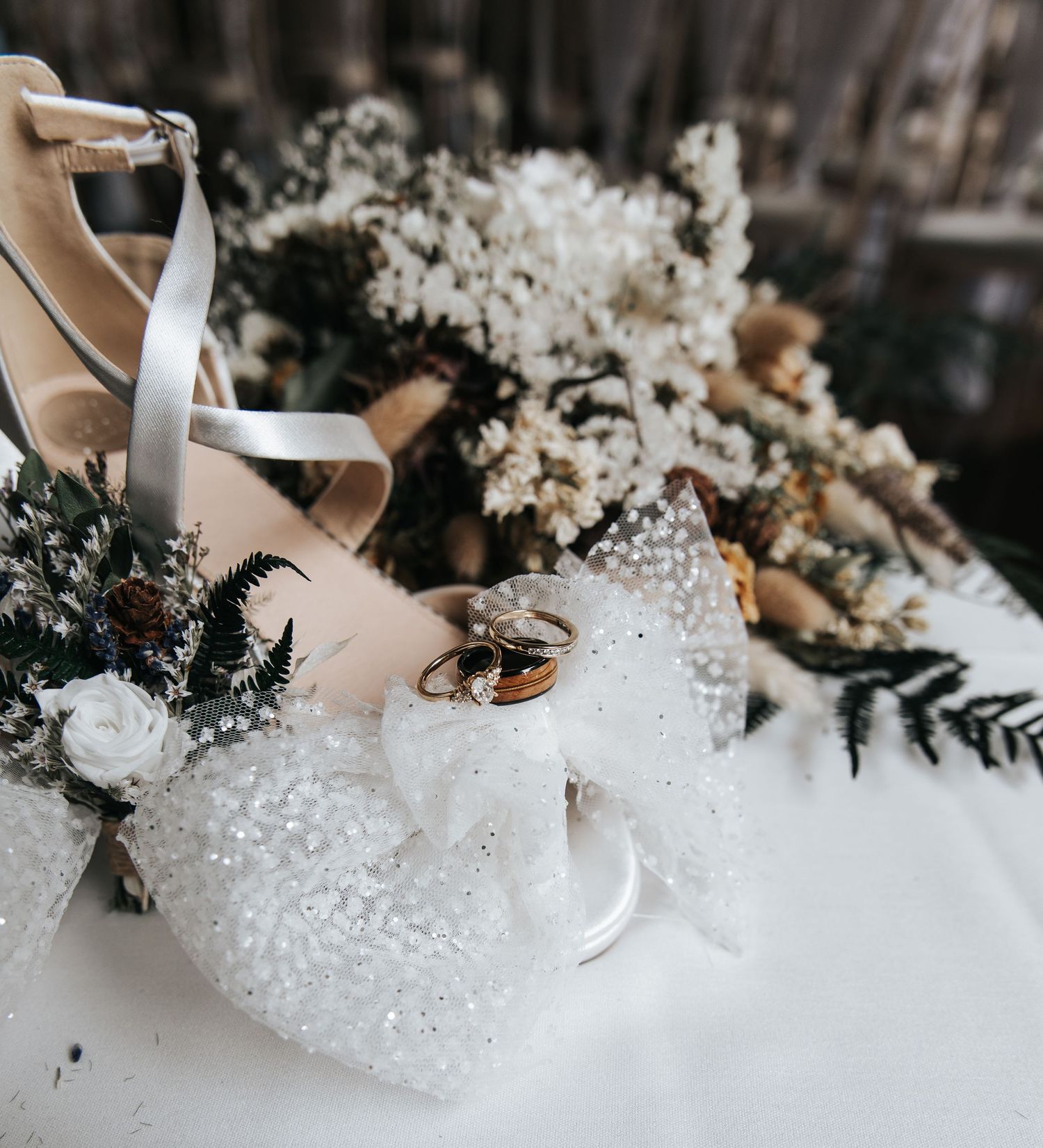 Close-up of bridal shoes and floral details with crystal embellishments.