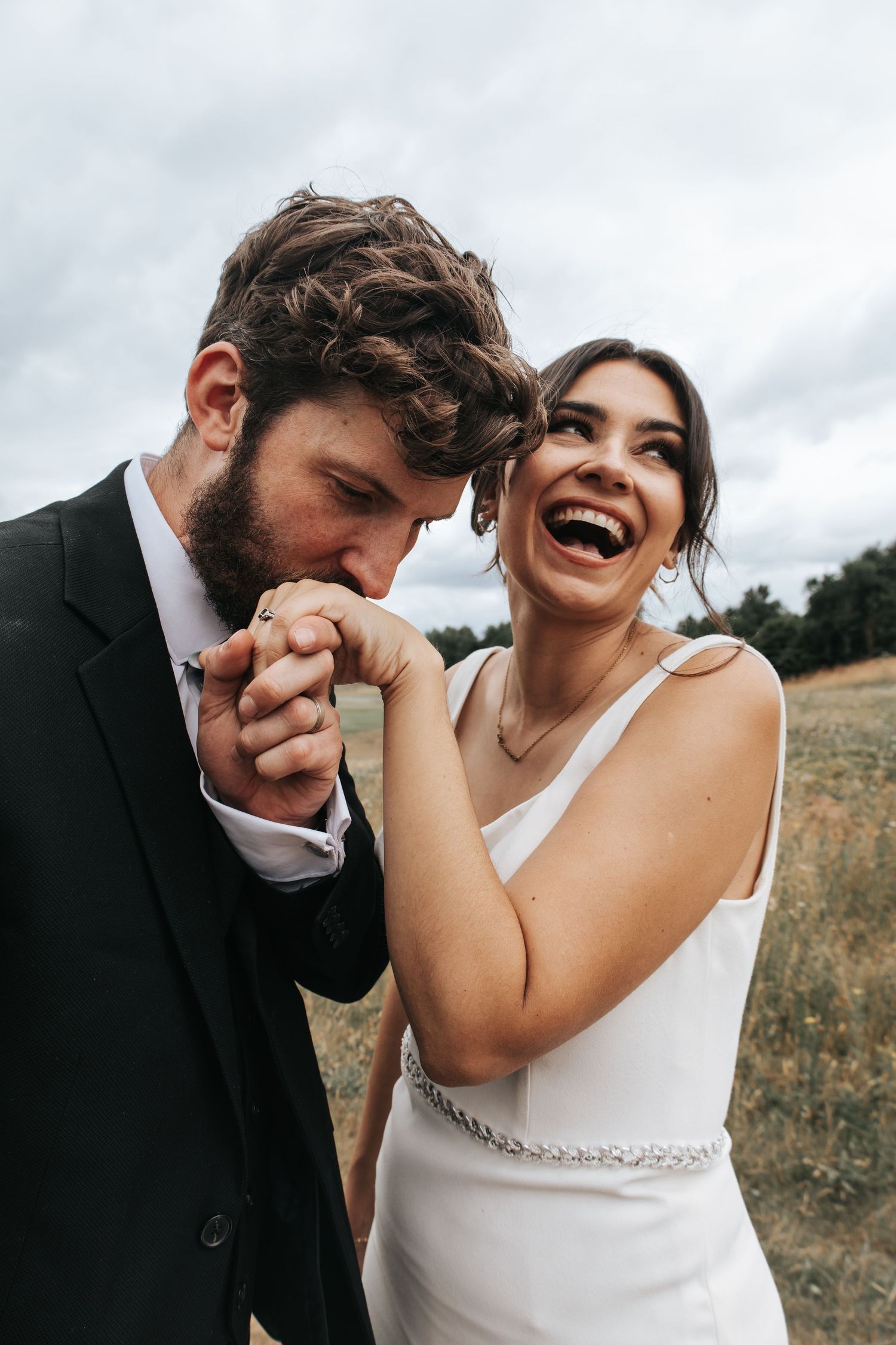 Candid wedding photography sequence showing joyful laughter between newlyweds in outdoor setting.