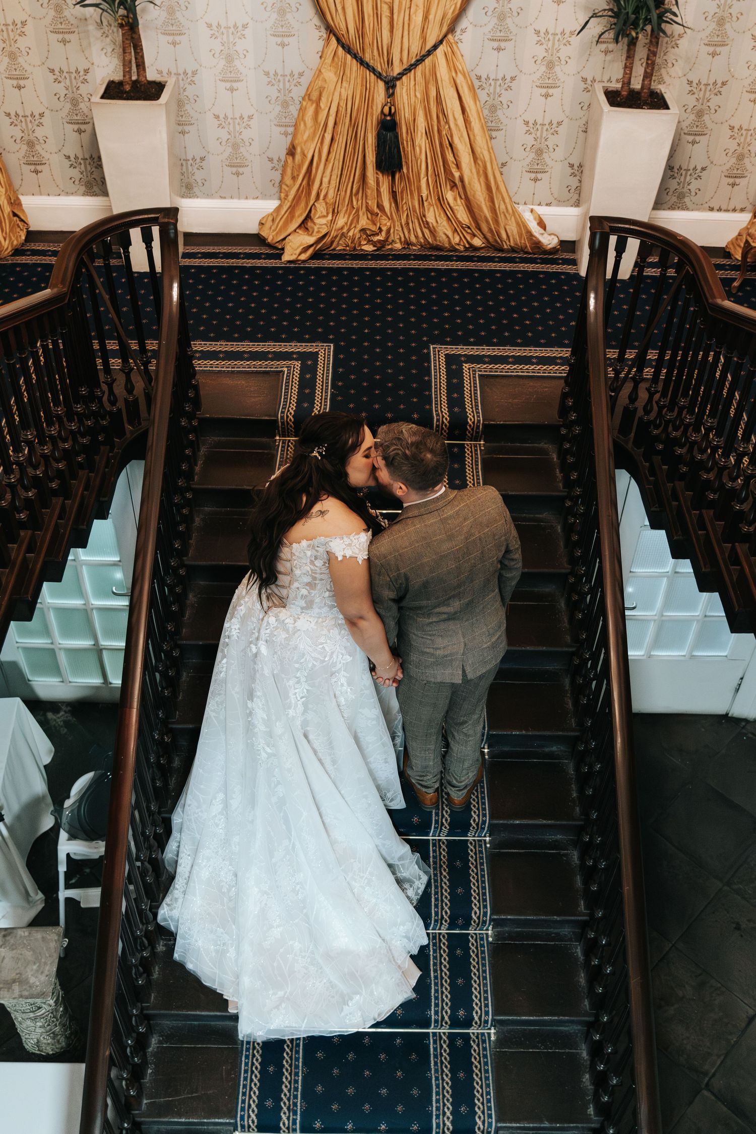 Overhead view of wedding venue with elegant seating arrangement and gold drapes.