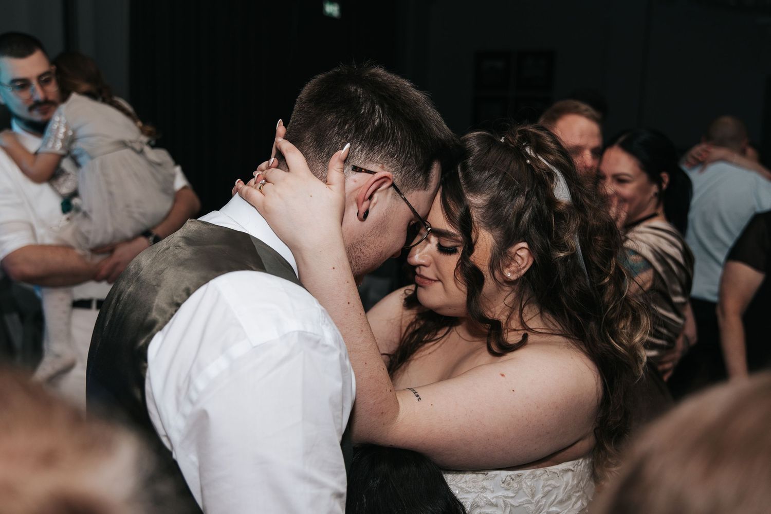 A tender moment captured between newlyweds during their first dance at the reception.