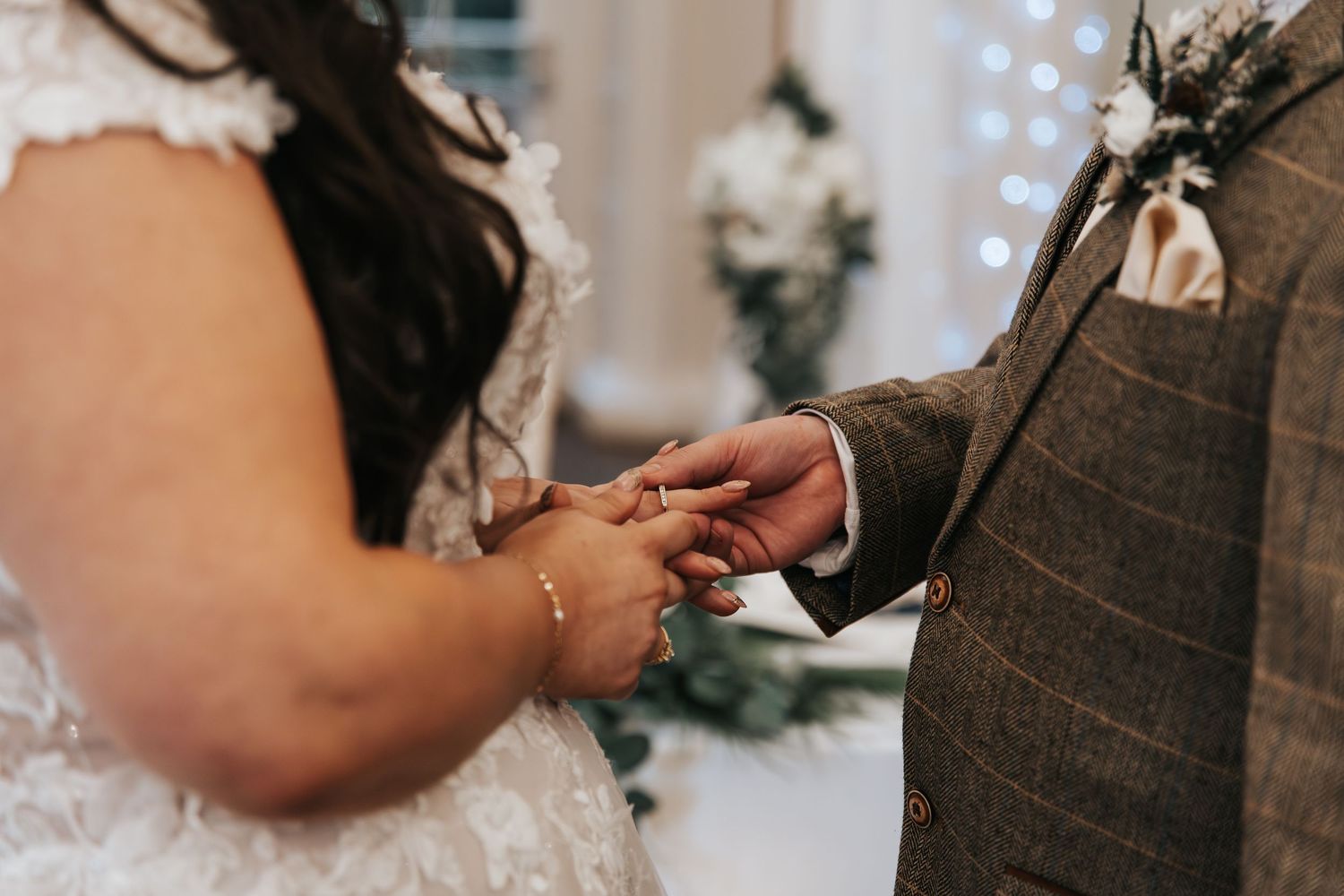 Close-up of a couple's hands during an intimate wedding moment.