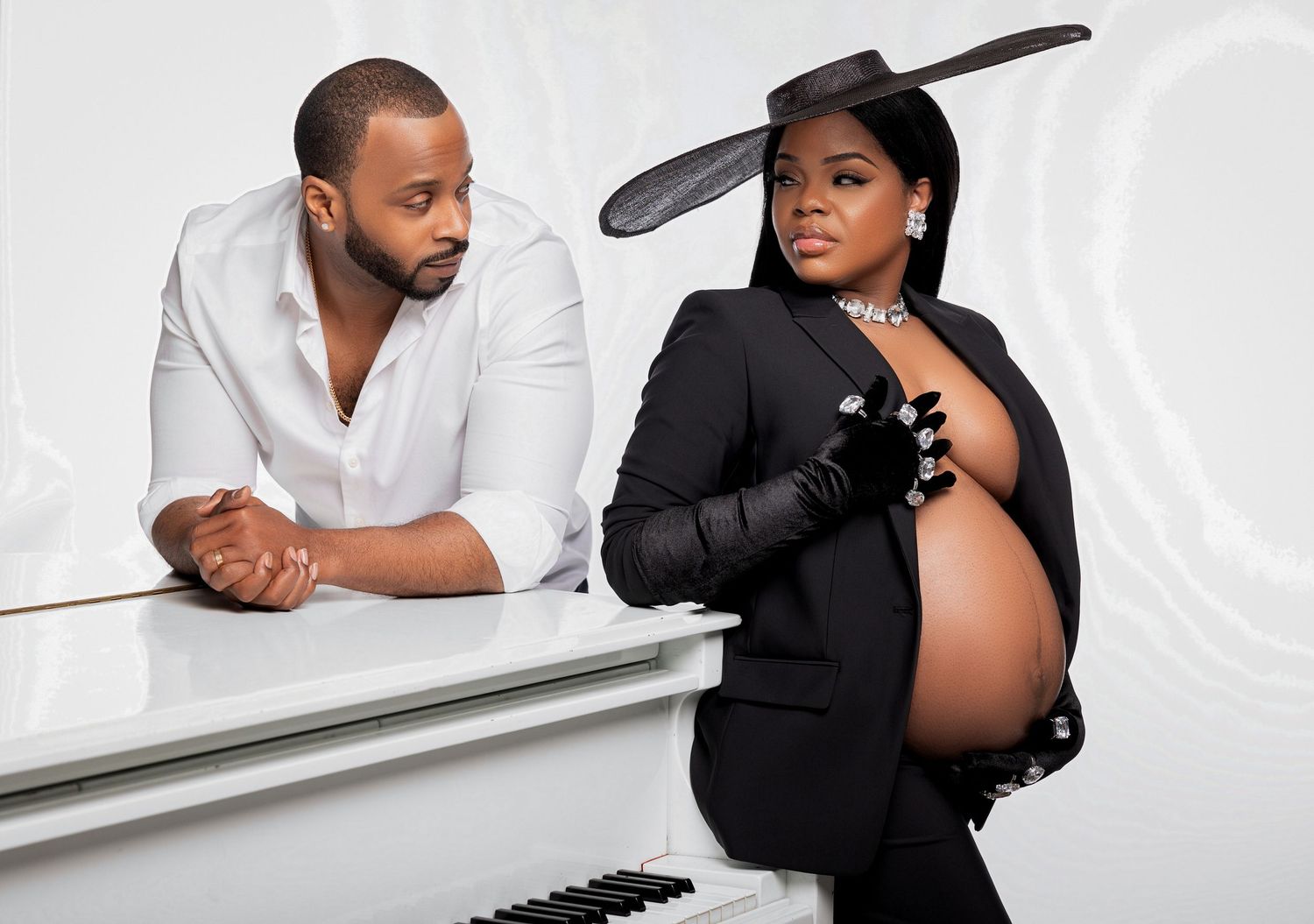 Black and white photo series showing intimate couple poses near a piano in a romantic photoshoot.